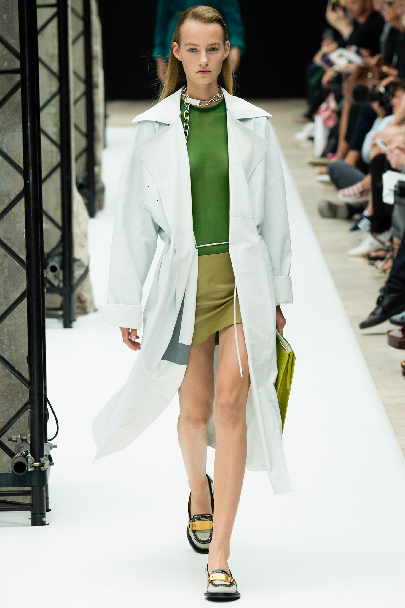 white coat green top beige skirt