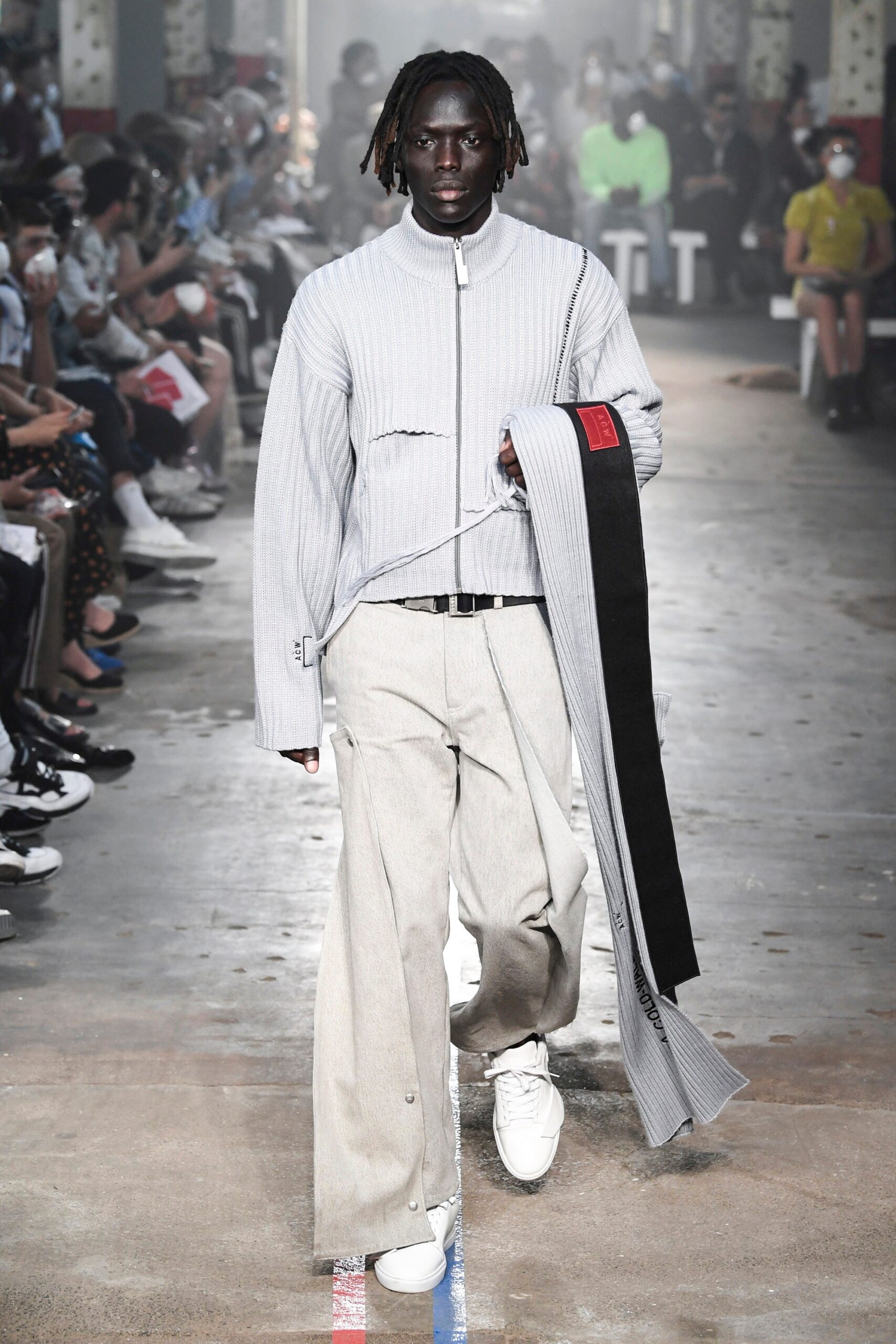 A relaxed gray cotton jacket with long sleeves and beige wide-leg pants.