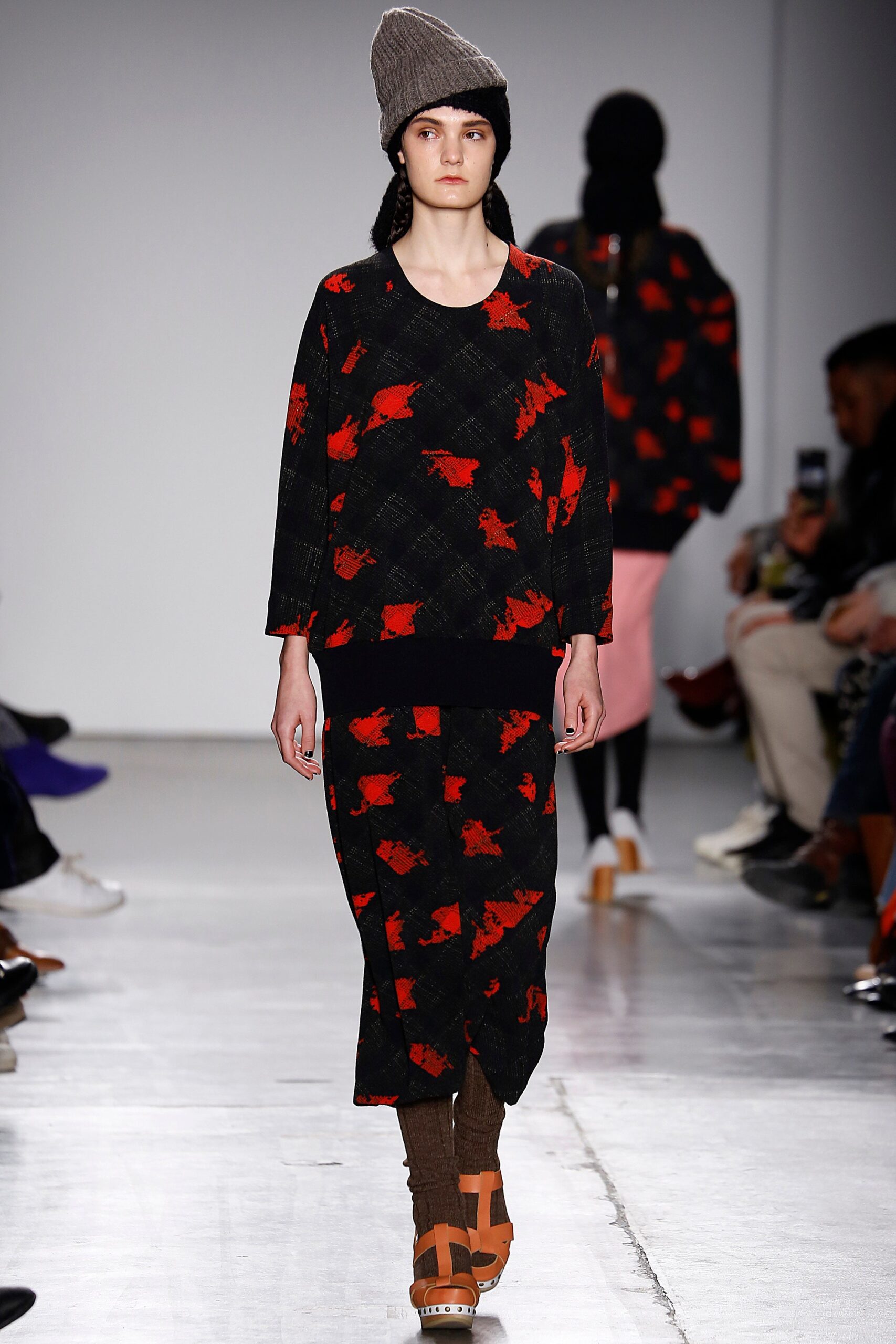 A relaxed black and red printed dress with long sleeves and a crew neckline.