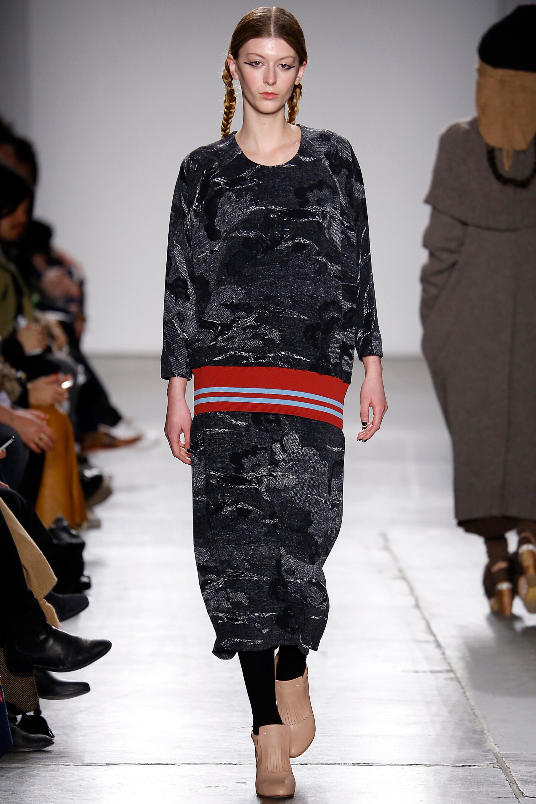 A relaxed black dress with long sleeves, a crew neckline, and a printed design.