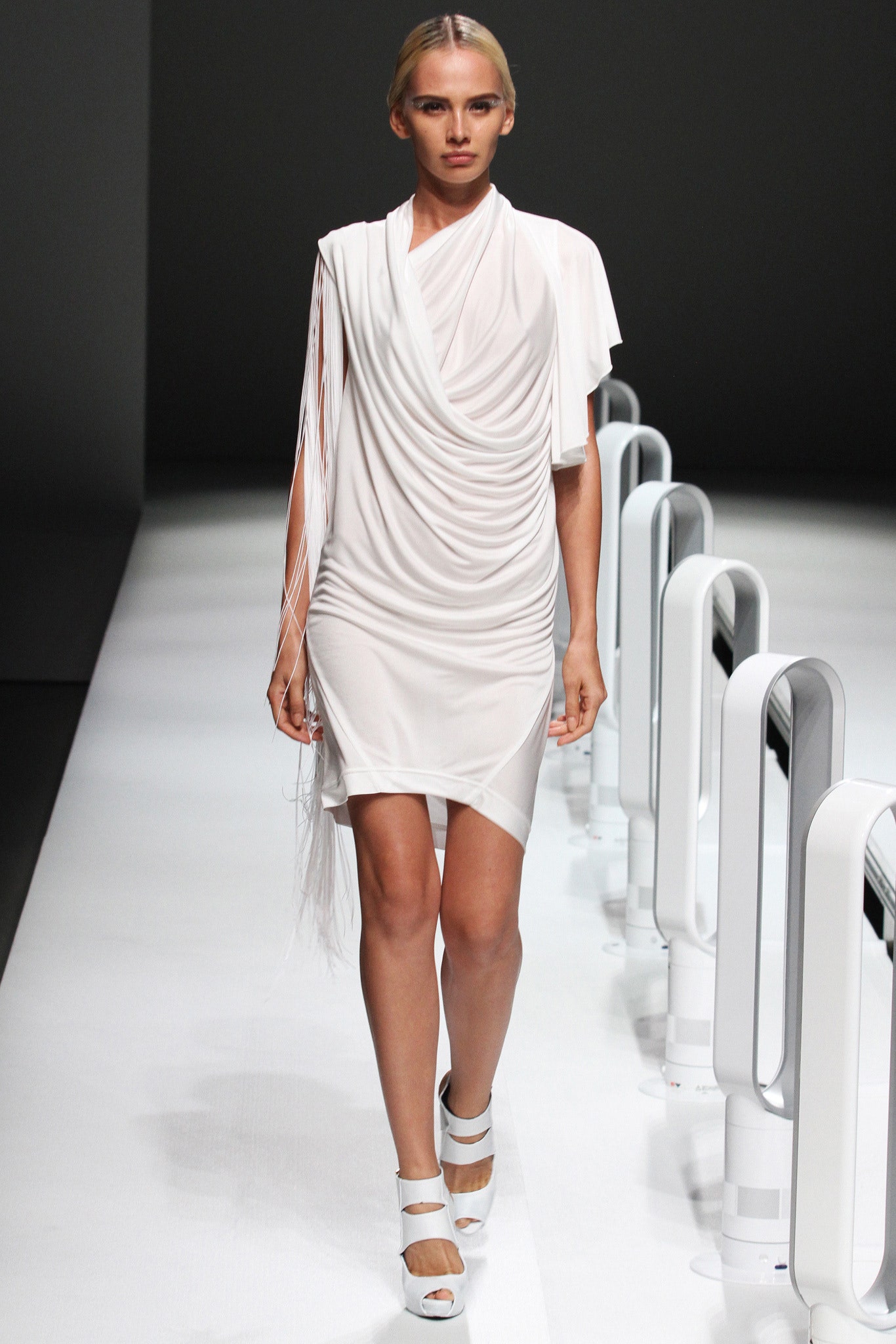 A fitted white silk dress with a sleeveless design and draped detailing.