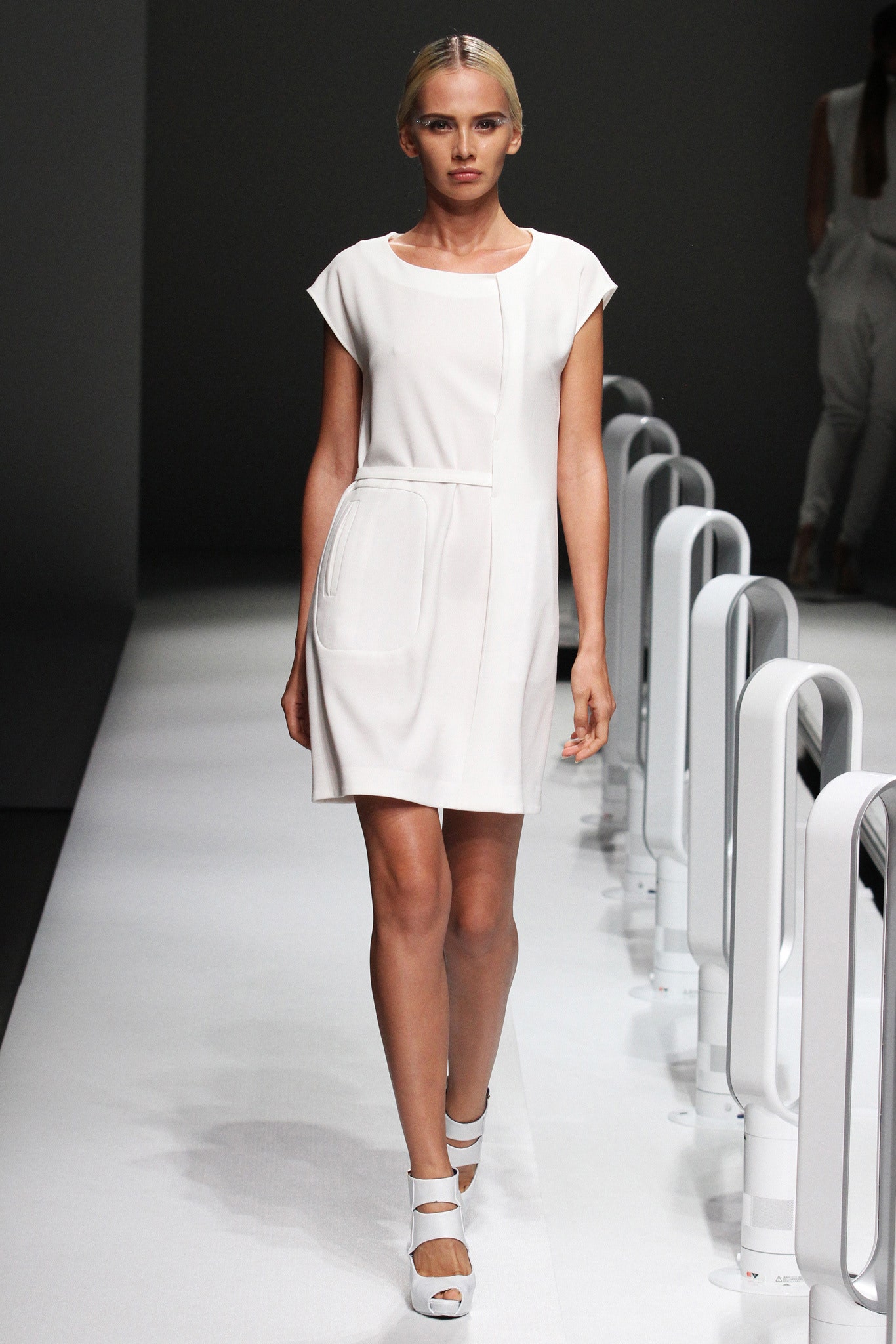 A fitted white short-sleeve dress with a collared neckline and straight silhouette.