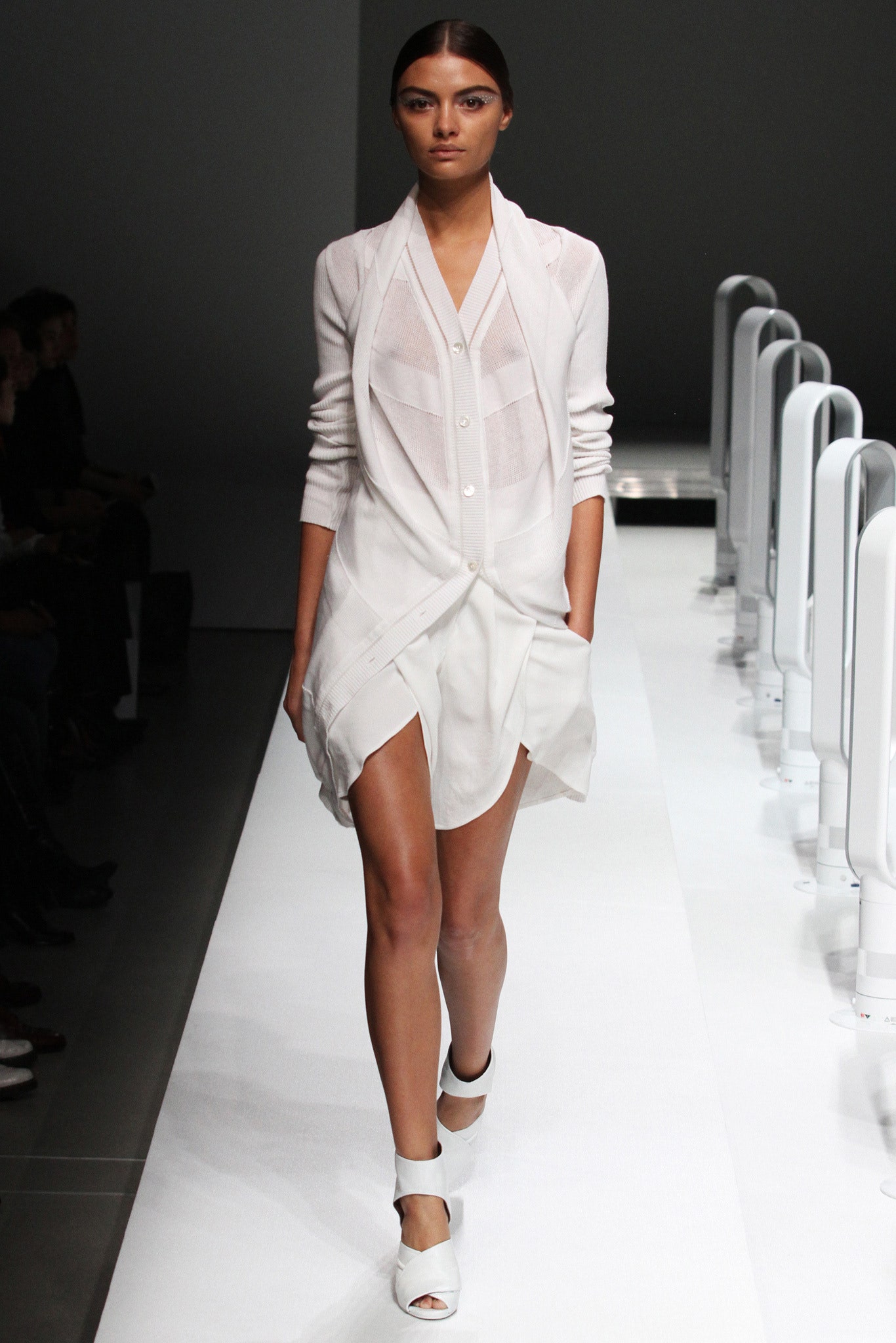 A relaxed white long-sleeve dress with a collared neckline and asymmetric design details.