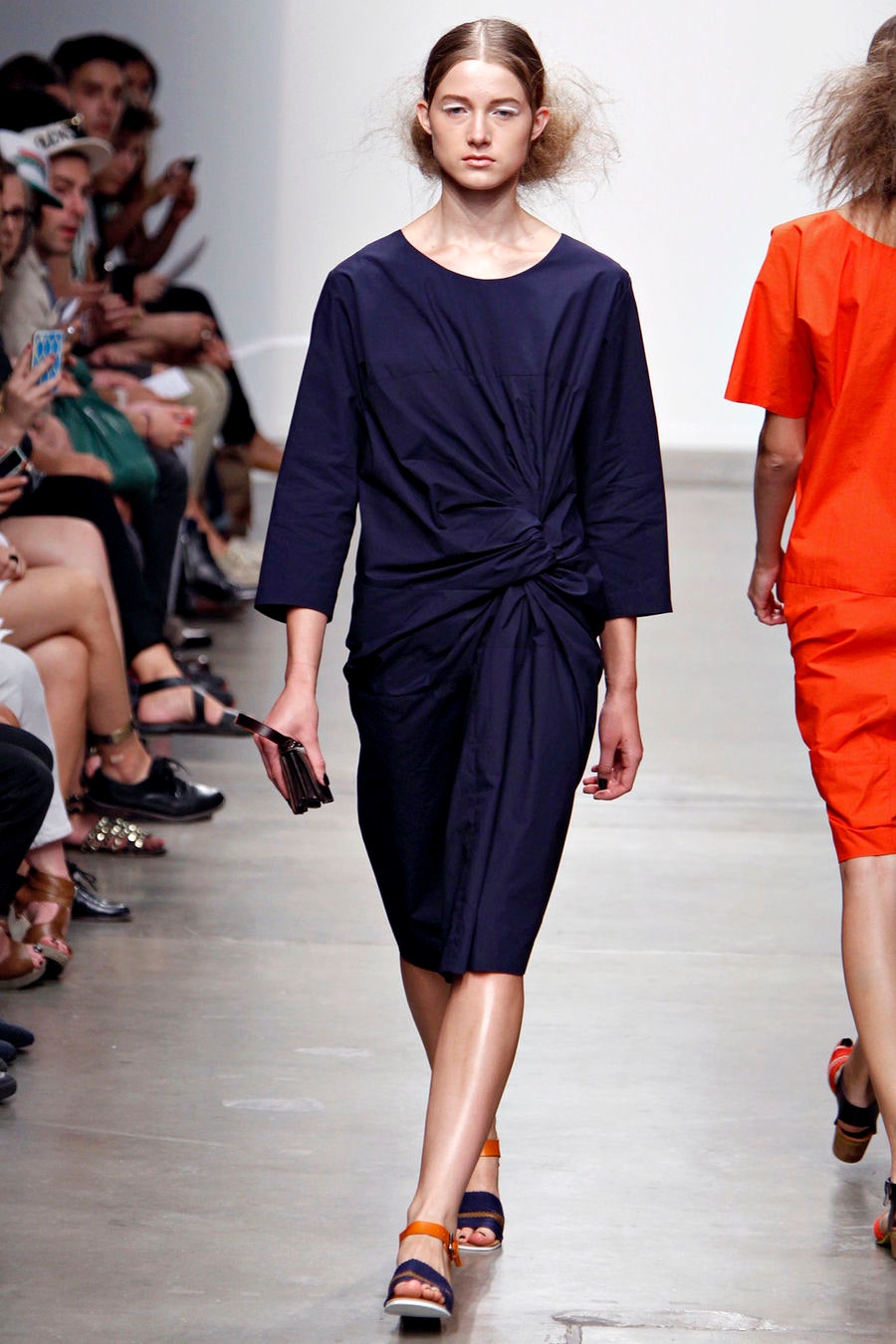 A relaxed blue cotton dress with three-quarter sleeves and an asymmetric design detail.