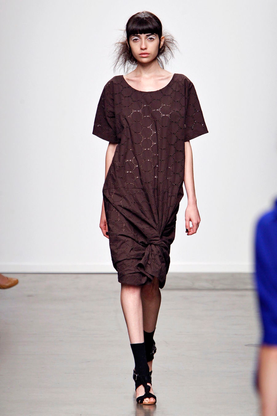A relaxed brown cotton dress with short sleeves and an asymmetric design.