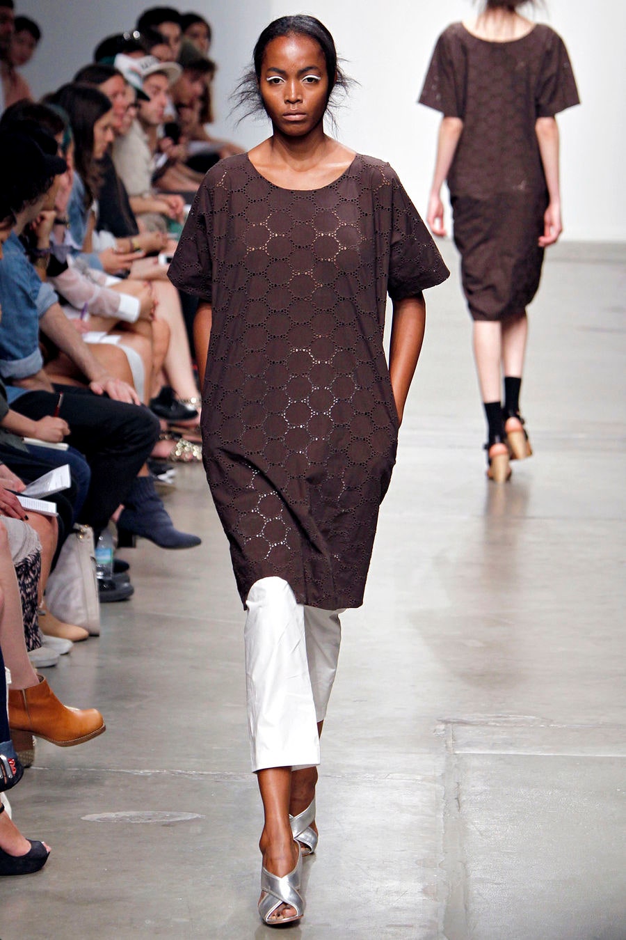 A relaxed brown printed dress paired with white pants, featuring short sleeves and a collared design.