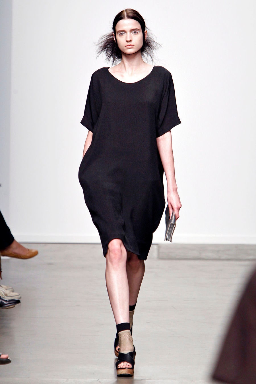 A relaxed black dress with short sleeves and an asymmetric design.