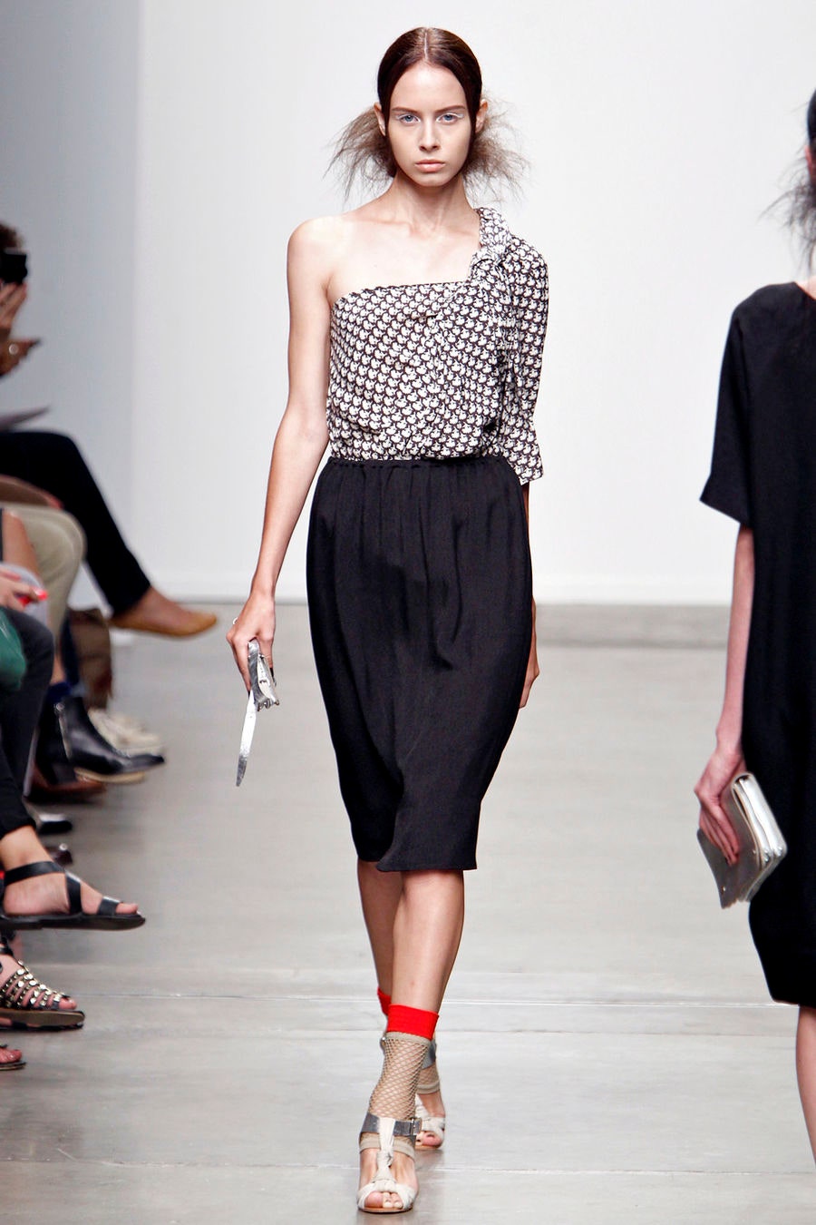 A relaxed black and white printed dress with a sleeveless design and asymmetric silhouette.
