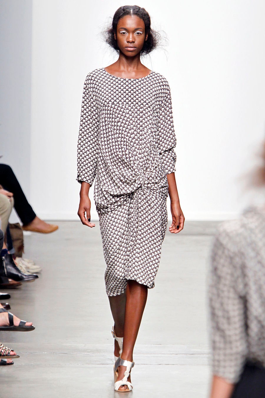 A relaxed long-sleeve dress with a collared neckline and printed design.