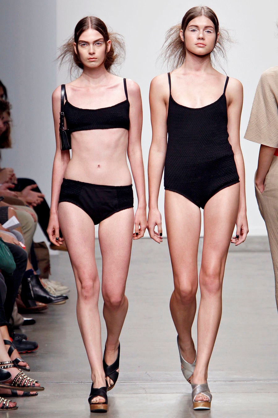 A fitted black bikini with a low-cut design and striped details.