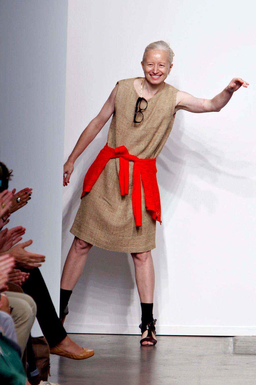 A relaxed beige sleeveless dress with a belted detail for added style.