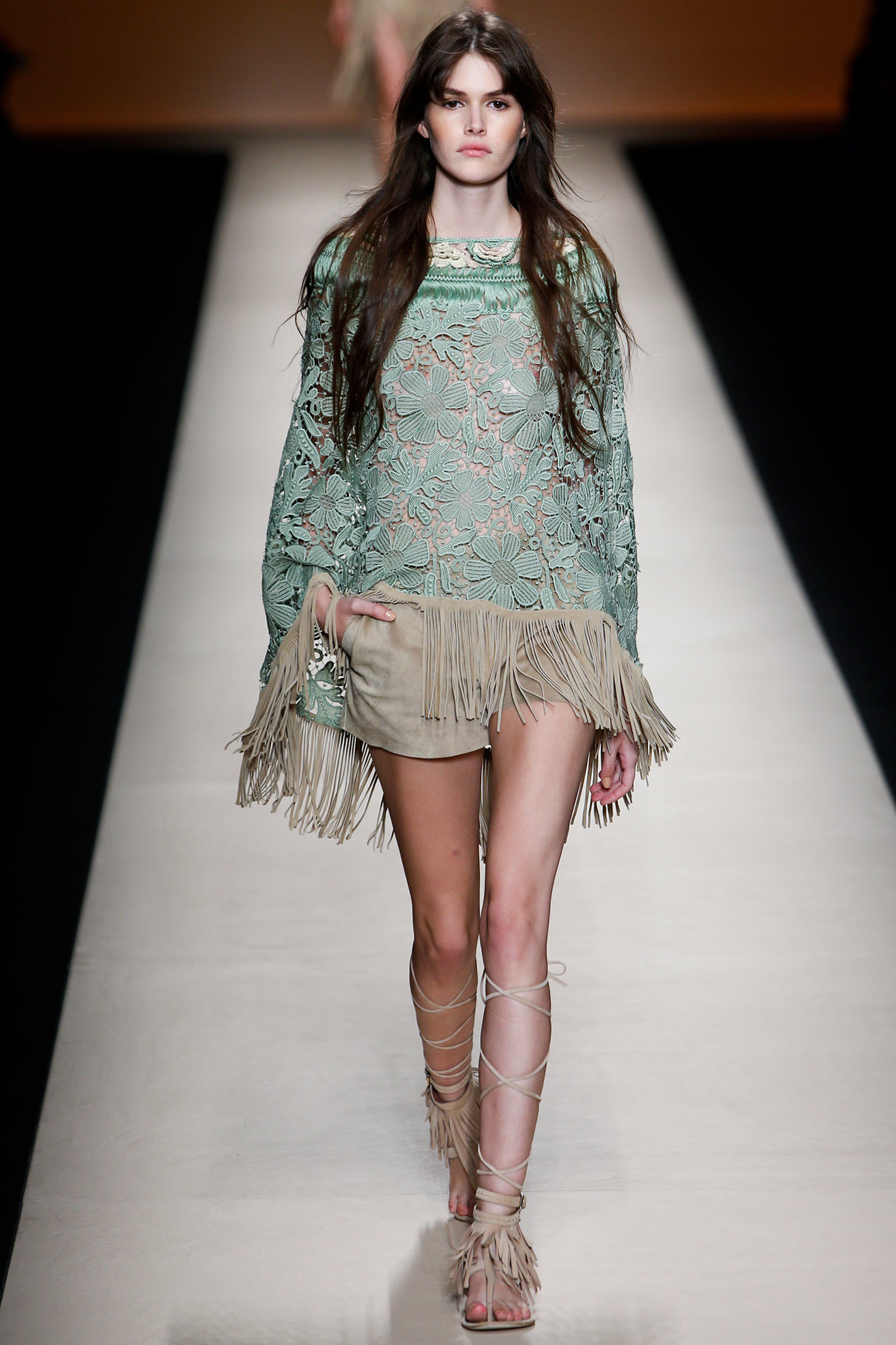 green lace poncho with beige shorts