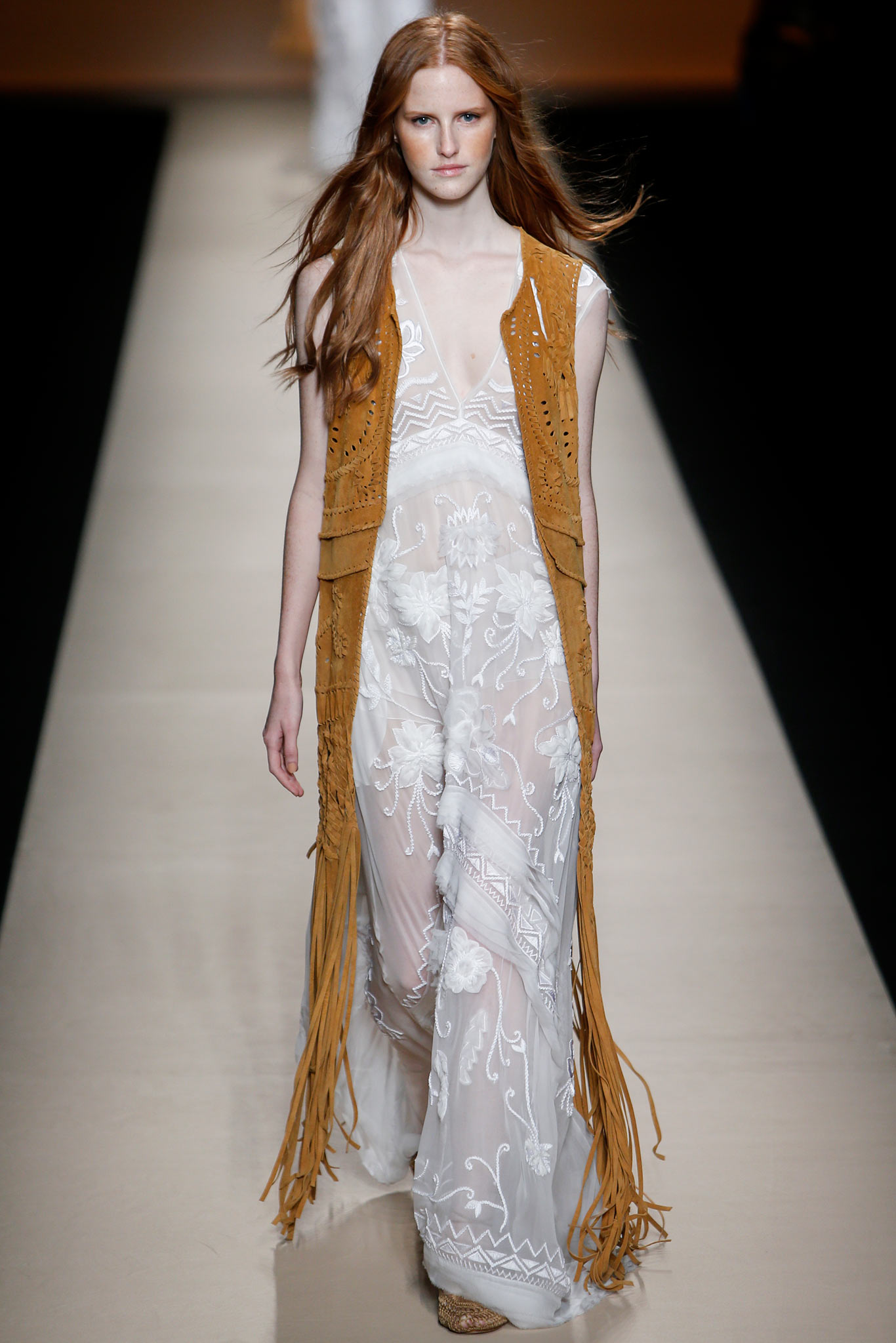 white embroidered maxi dress with brown fringed vest