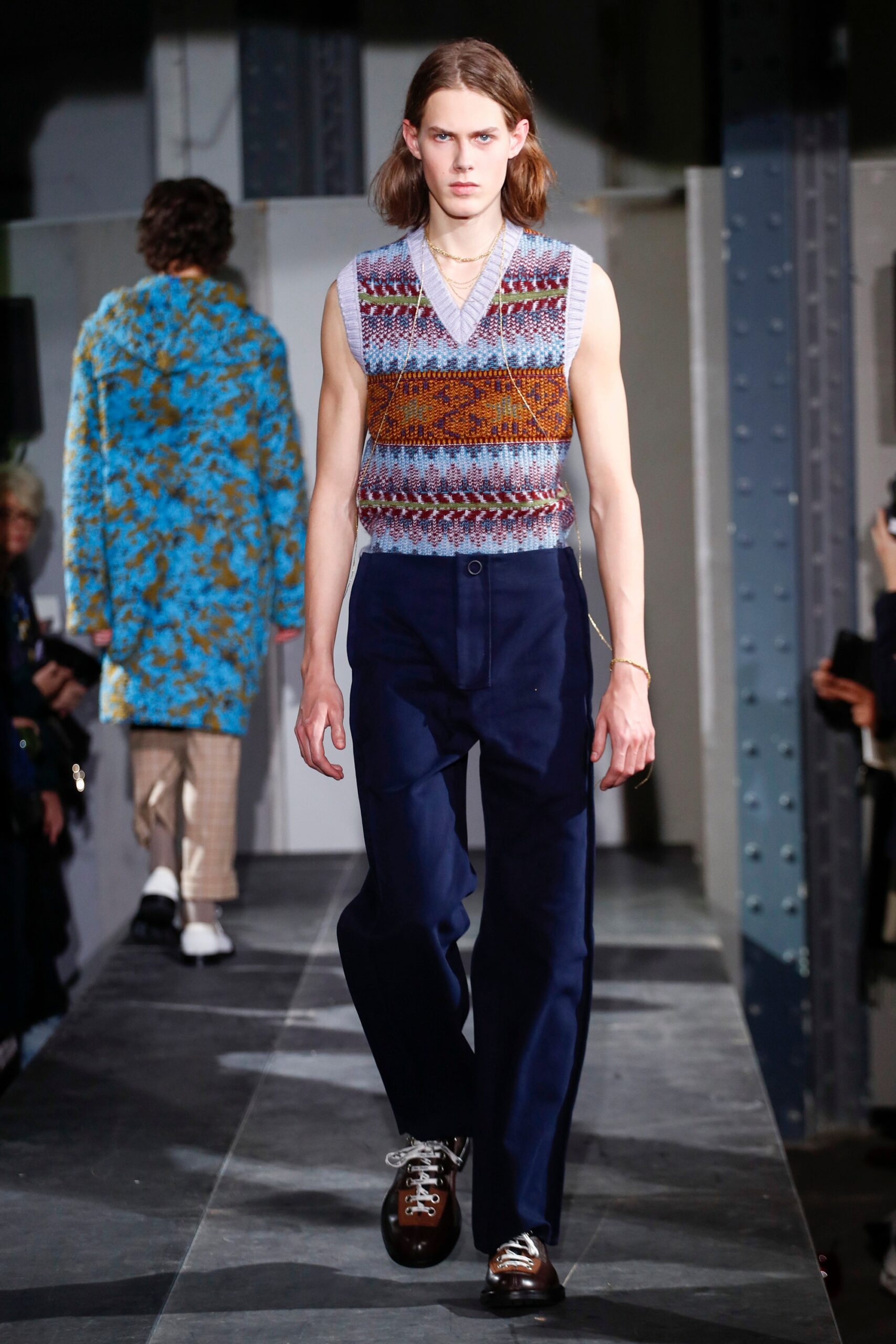 multi-colored sleeveless sweater and tailored pants