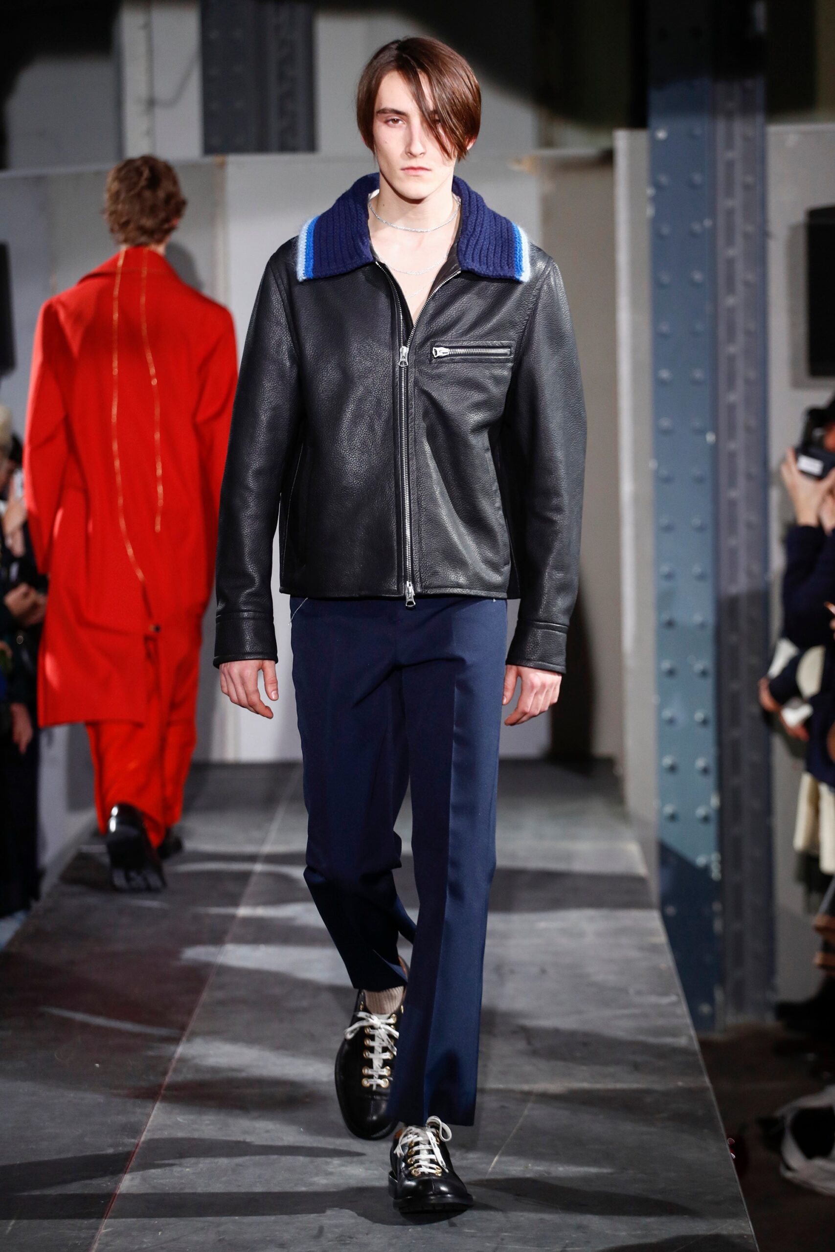 black leather jacket and blue pants