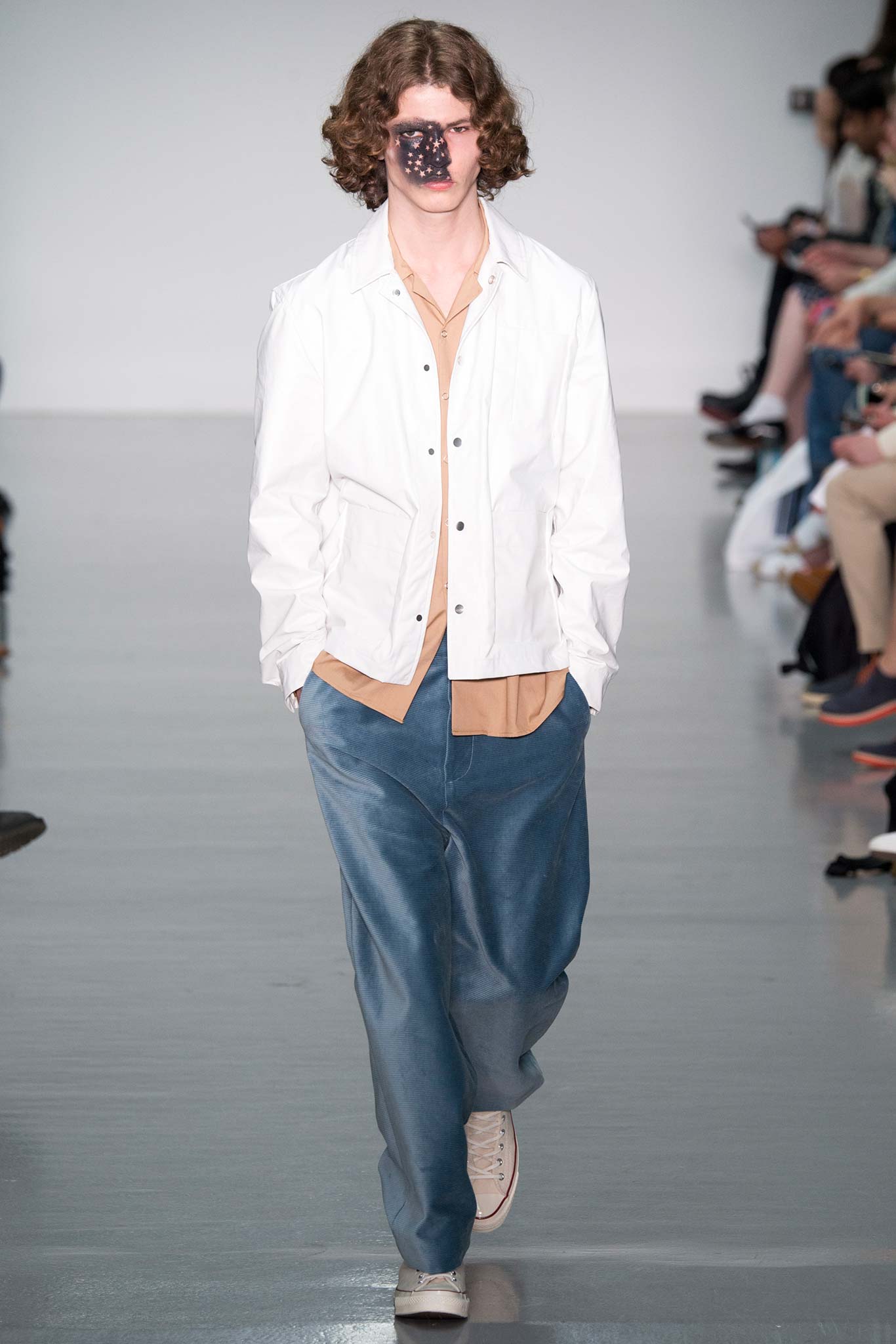 white jacket beige shirt blue pants