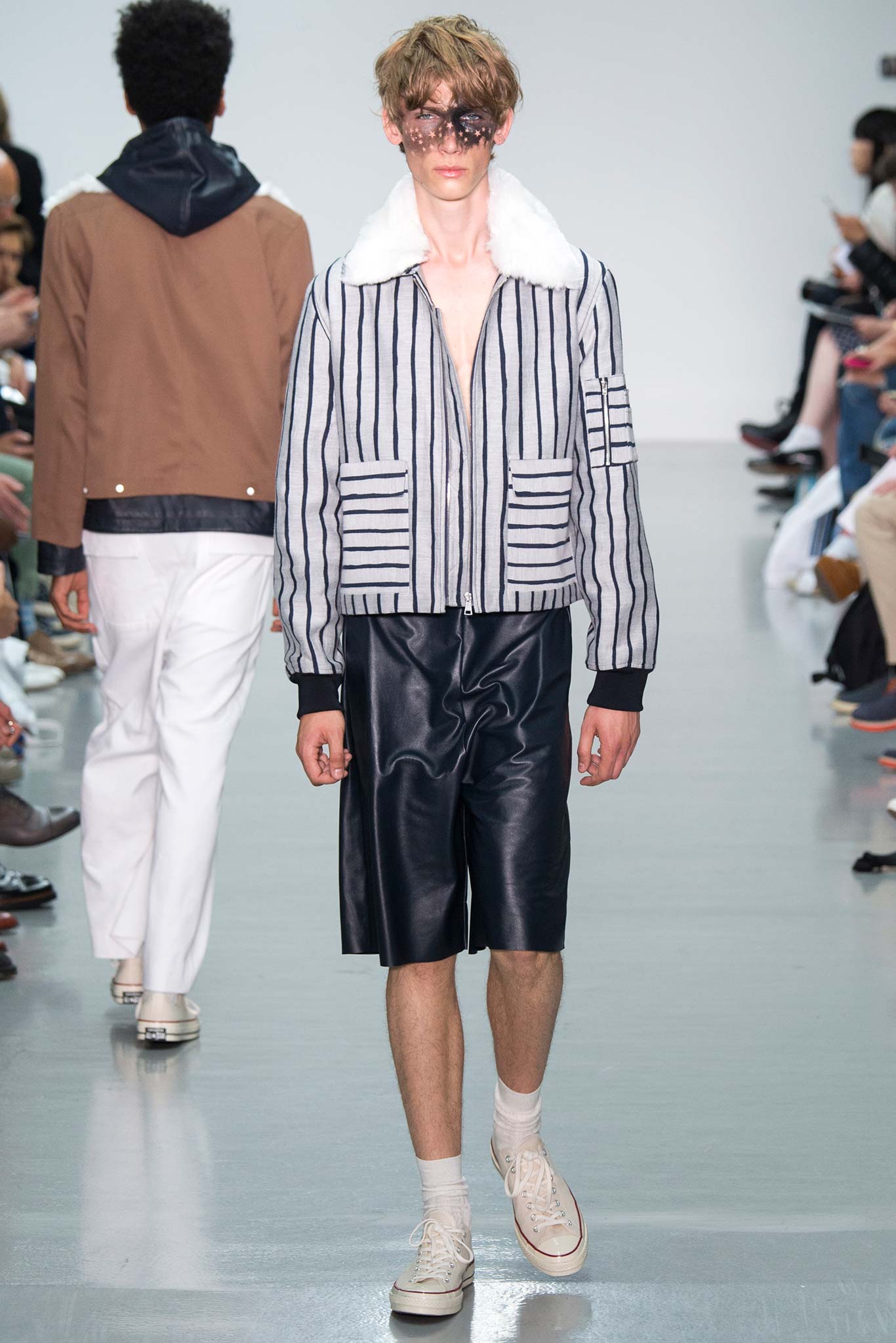 striped jacket and black leather shorts