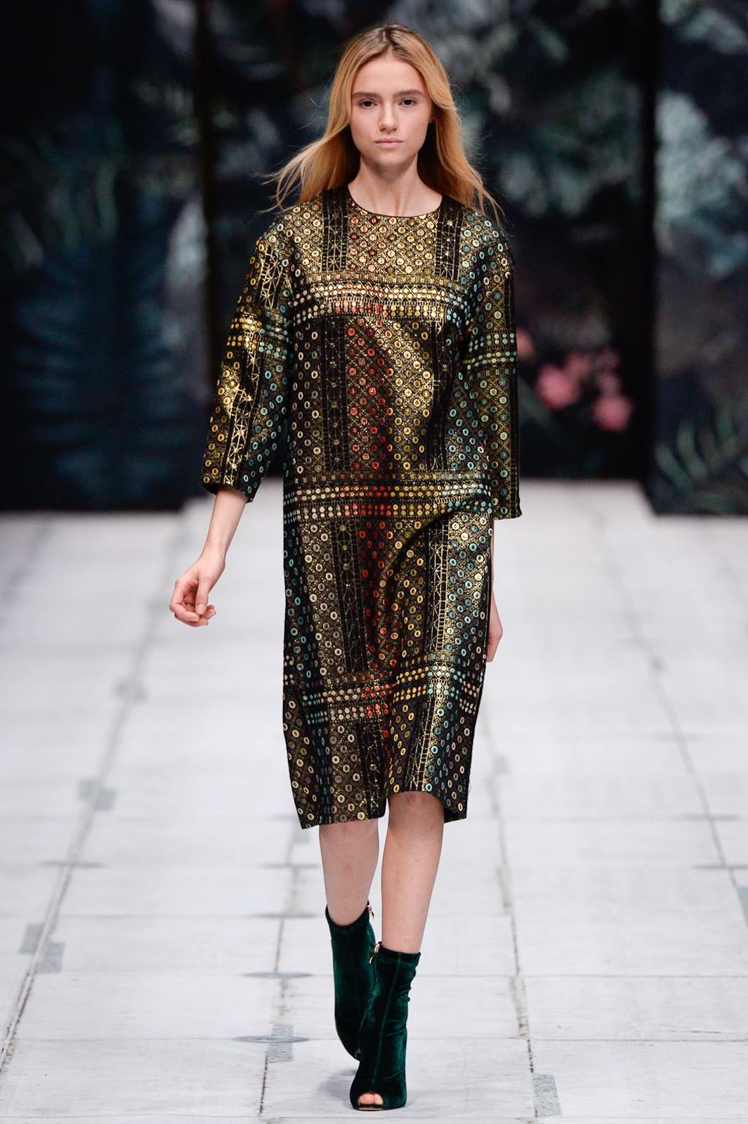 relaxed black and gold printed midi dress with green boots