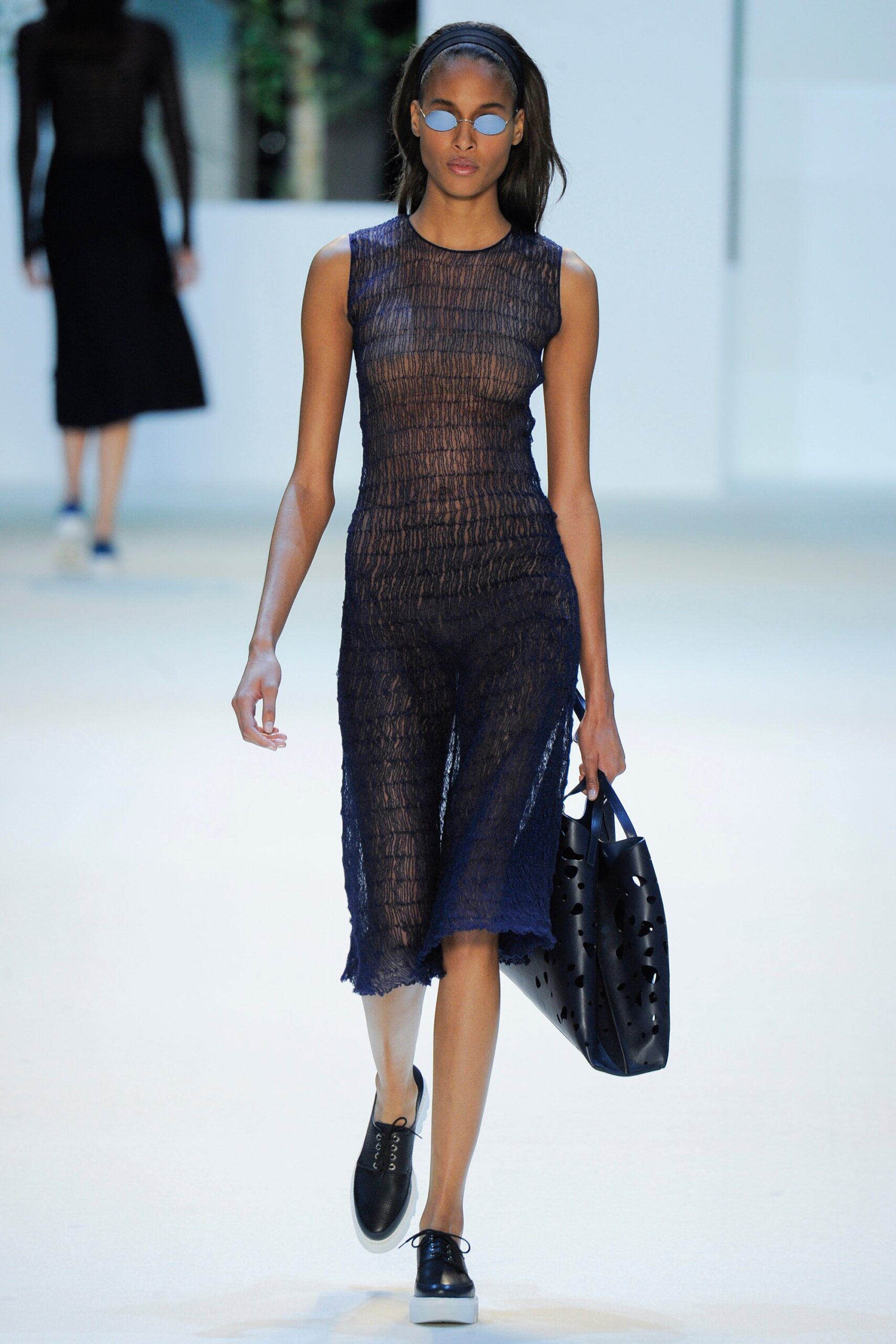 blue mesh sleeveless dress with black bag
