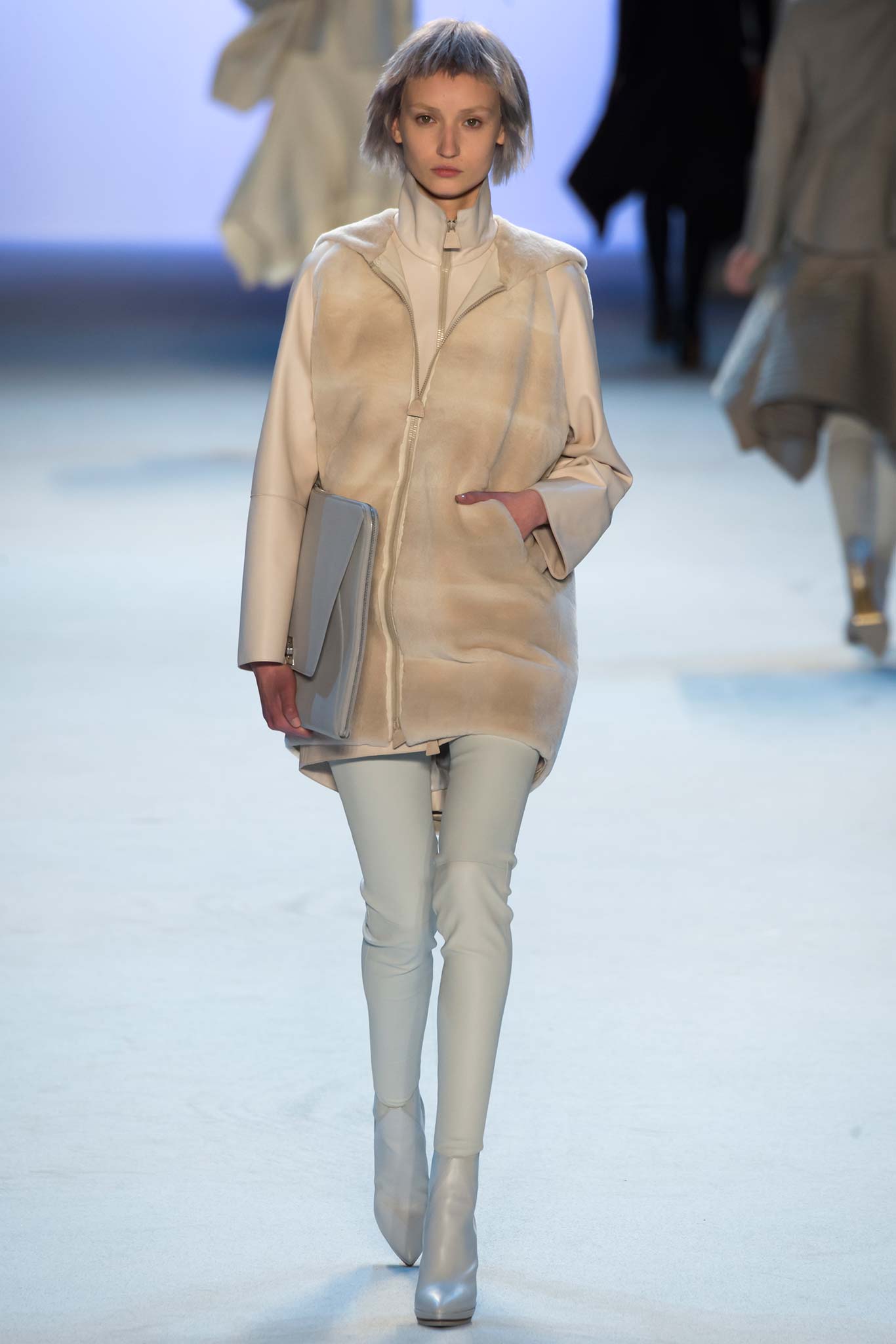 beige leather coat with light blue pants