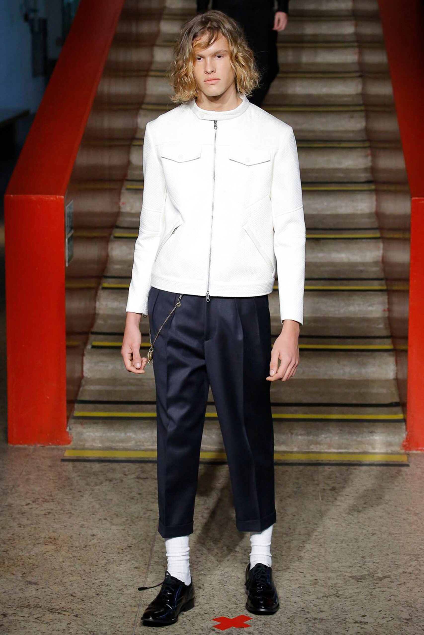 white leather fitted jacket and black relaxed pants