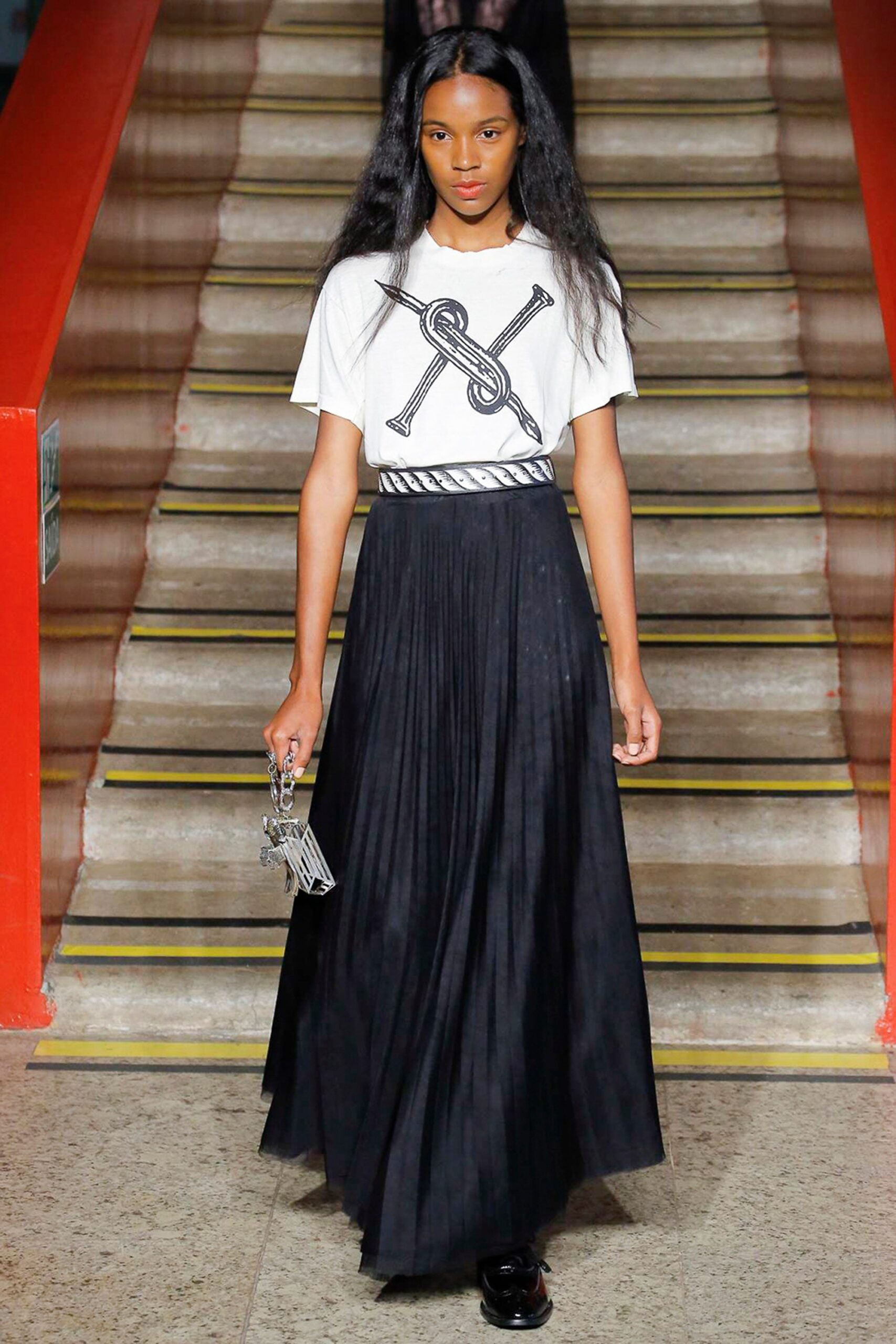 white printed top with black pleated skirt