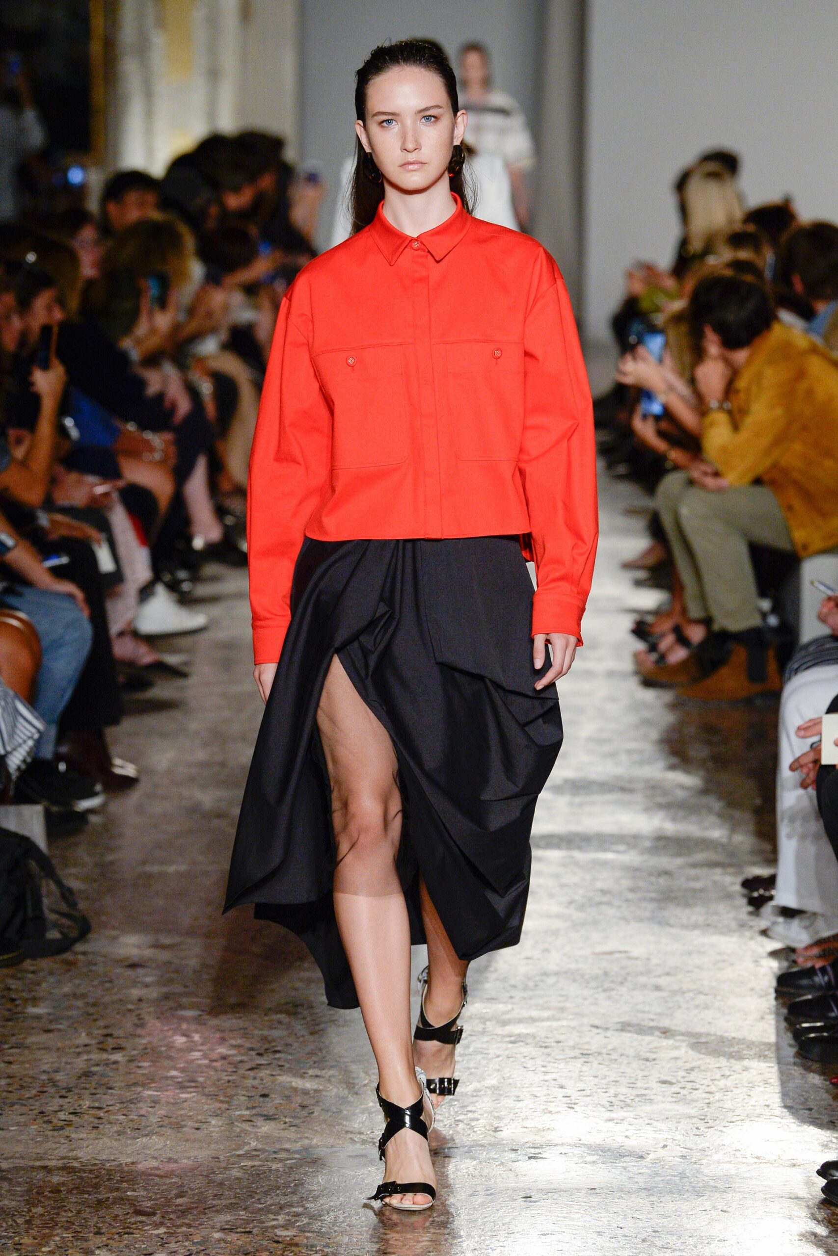 red relaxed shirt and black midi skirt