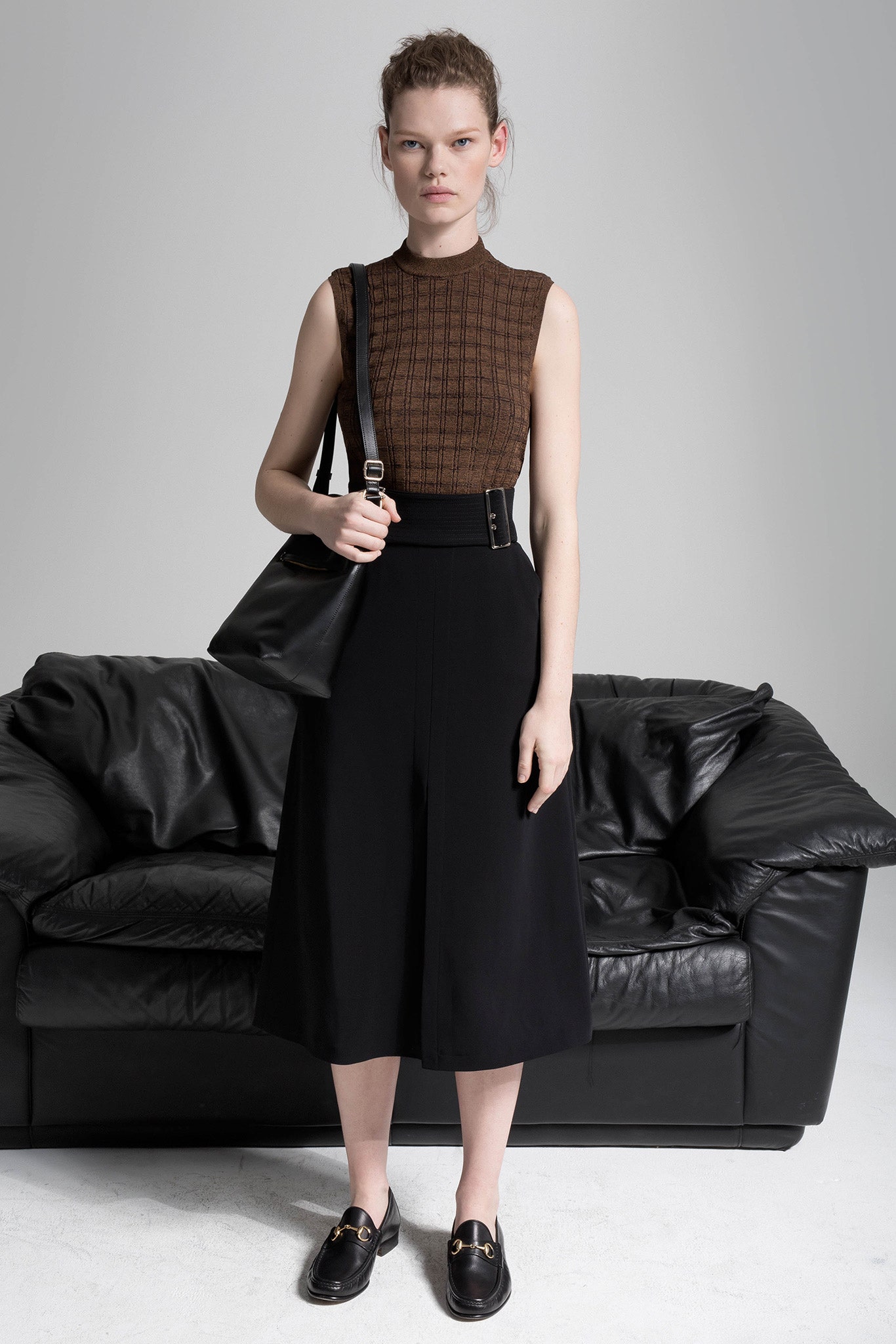 brown fitted sleeveless top and black culottes