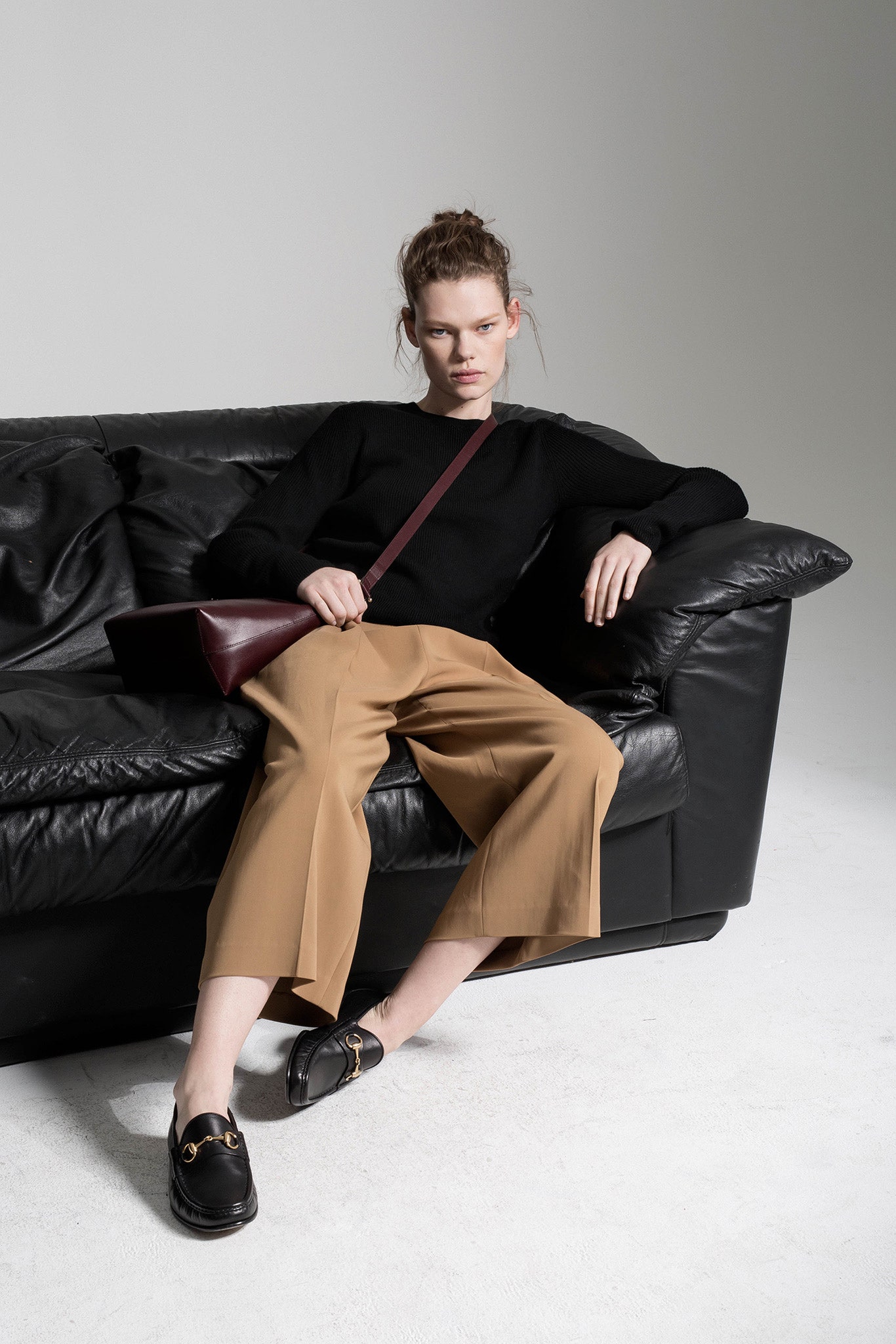 black wool fitted top with beige wide-leg pants