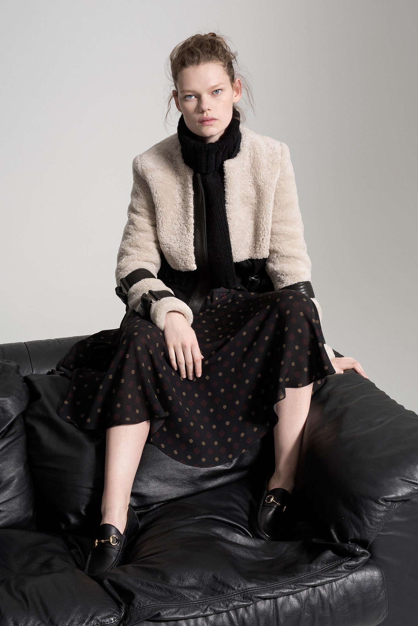 beige faux-fur jacket and black dress