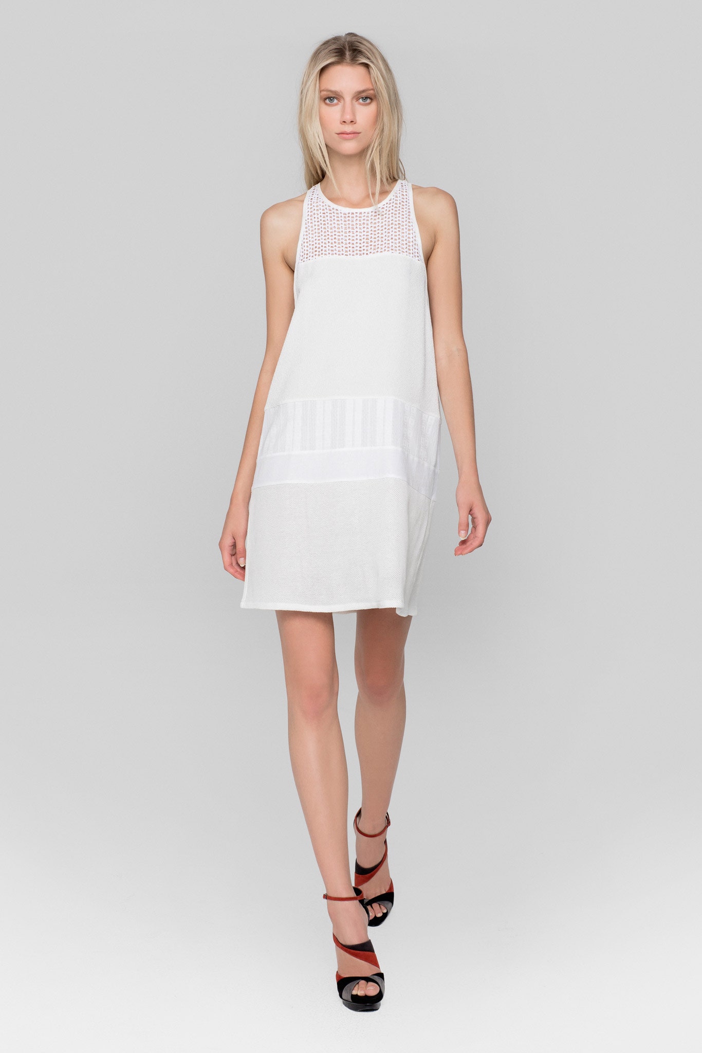 white relaxed sleeveless dress with black shoes