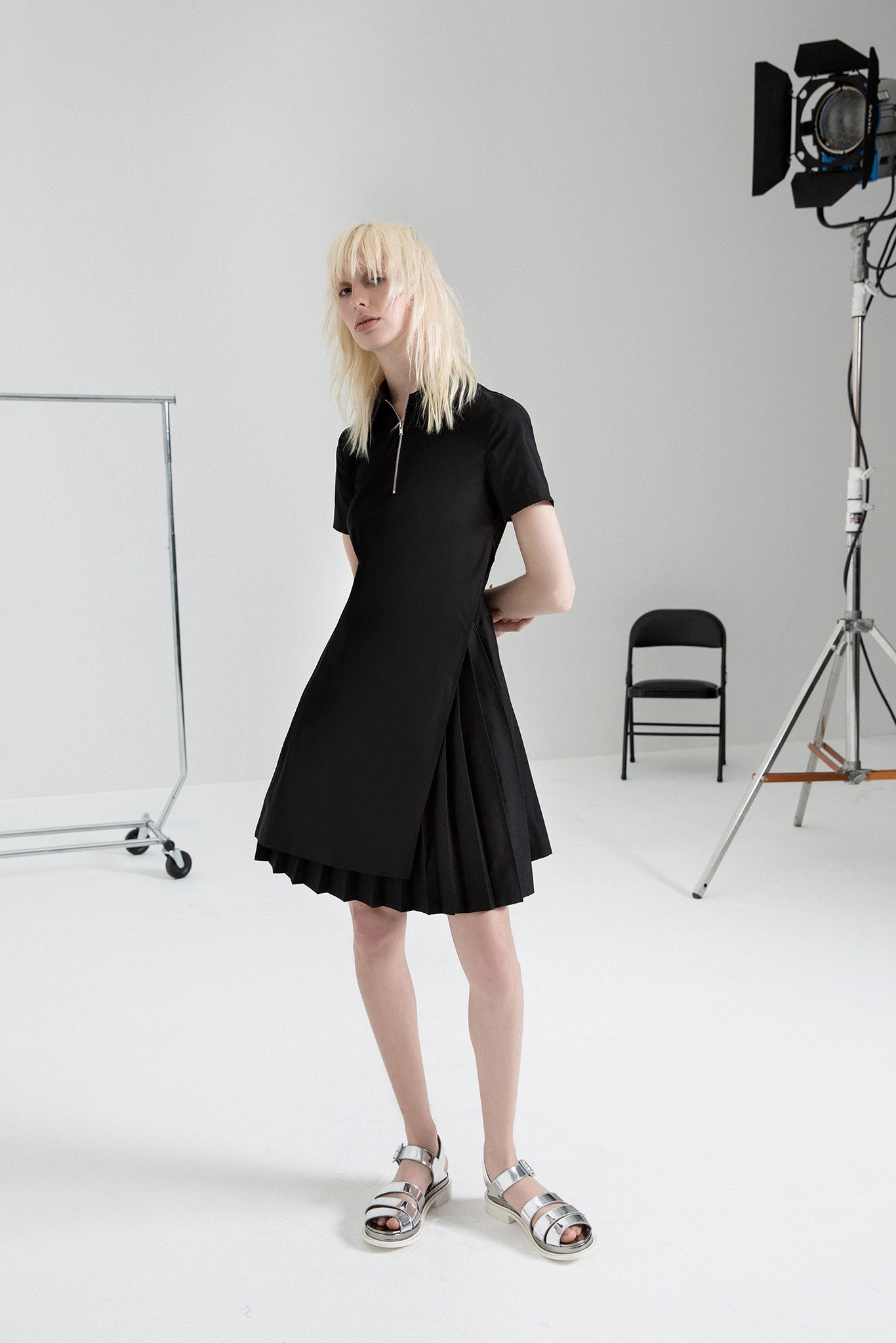 black pleated mini dress with silver shoes
