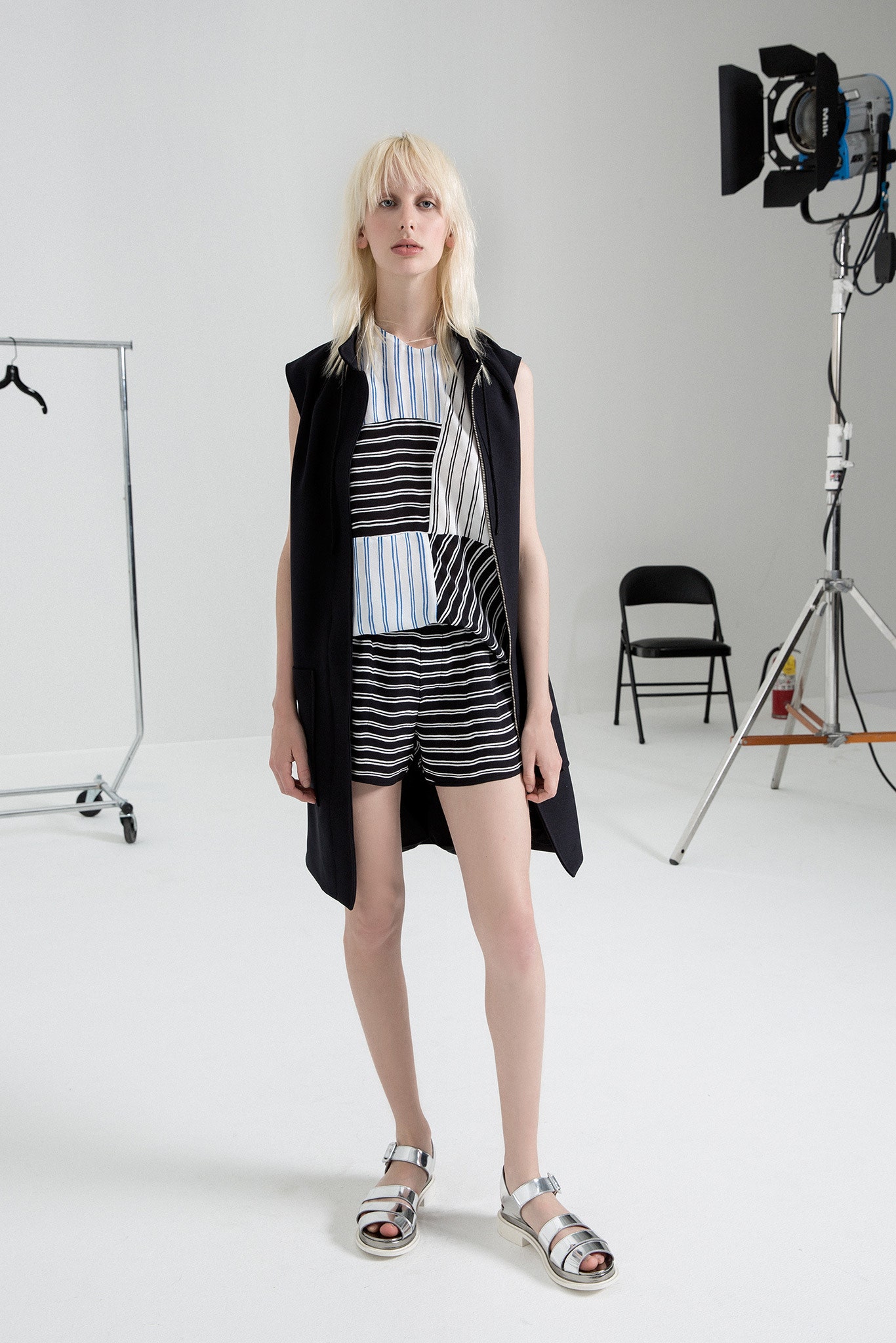 black sleeveless jacket with striped top and shorts