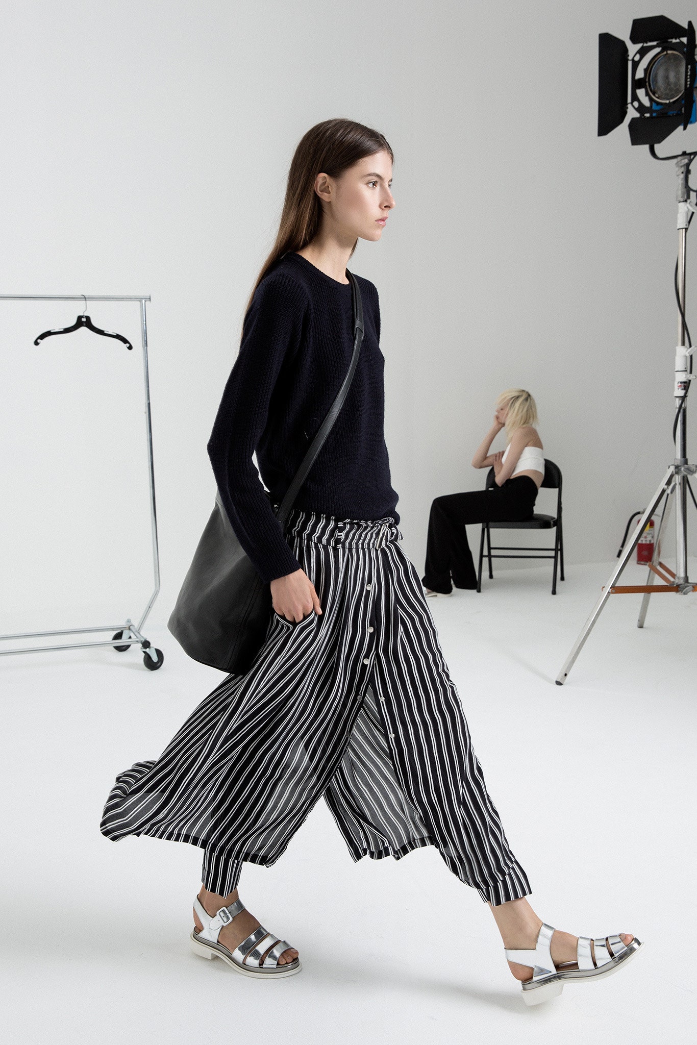 black relaxed top with striped pants