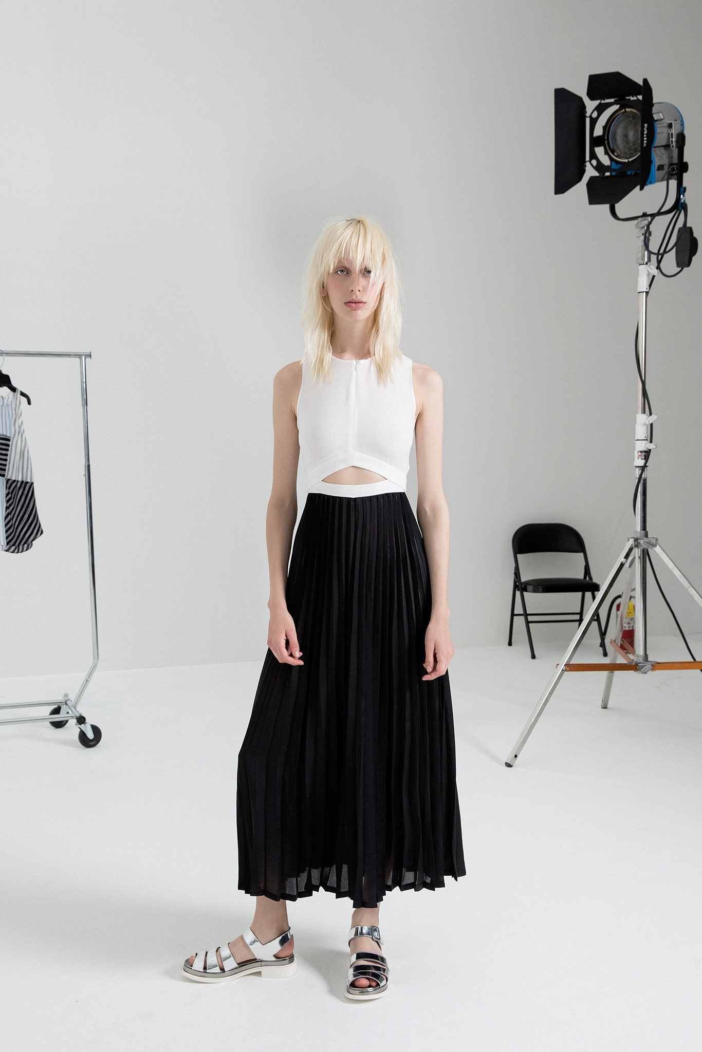white fitted top black pleated skirt