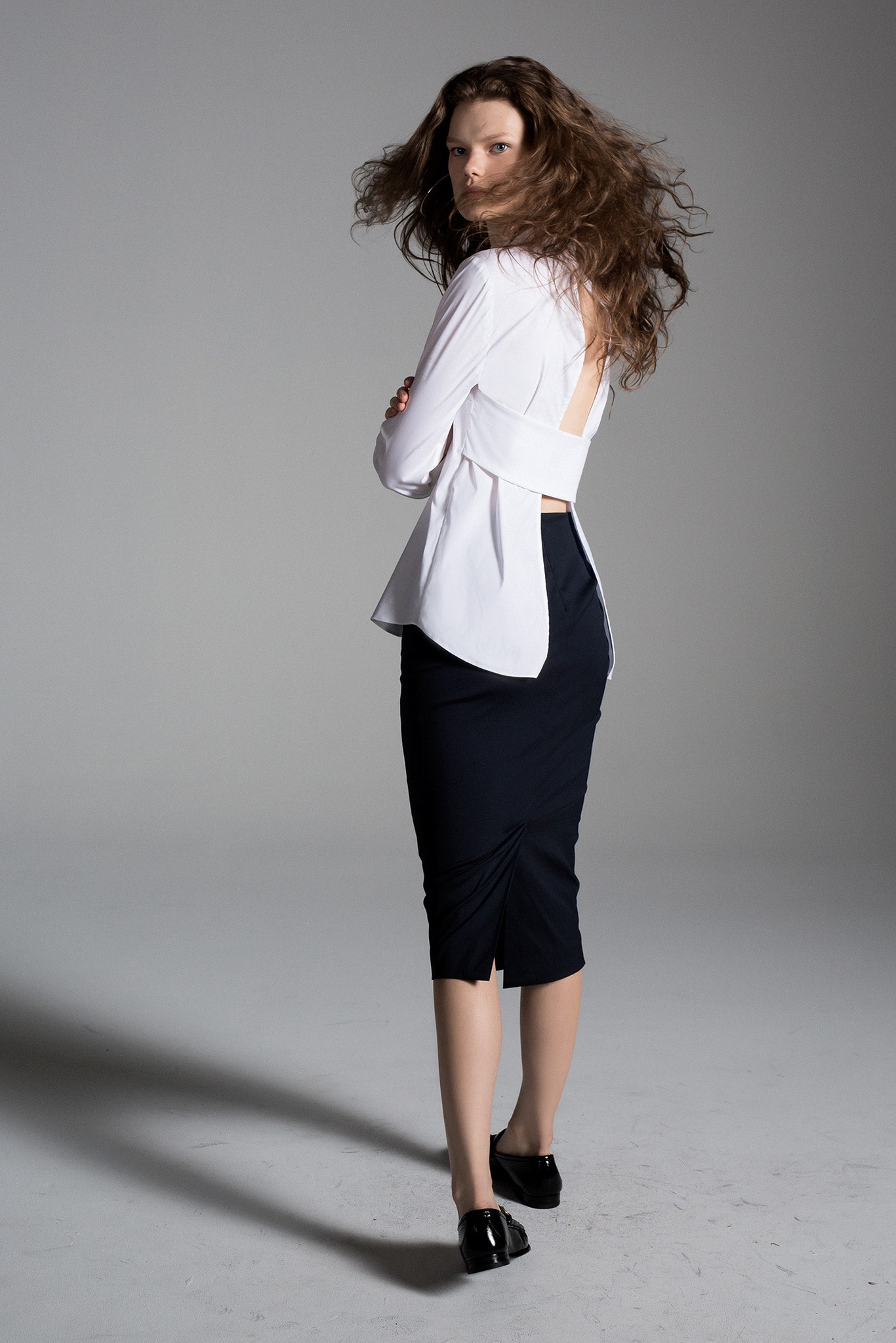 white cotton long-sleeve backless fitted draped blouse
