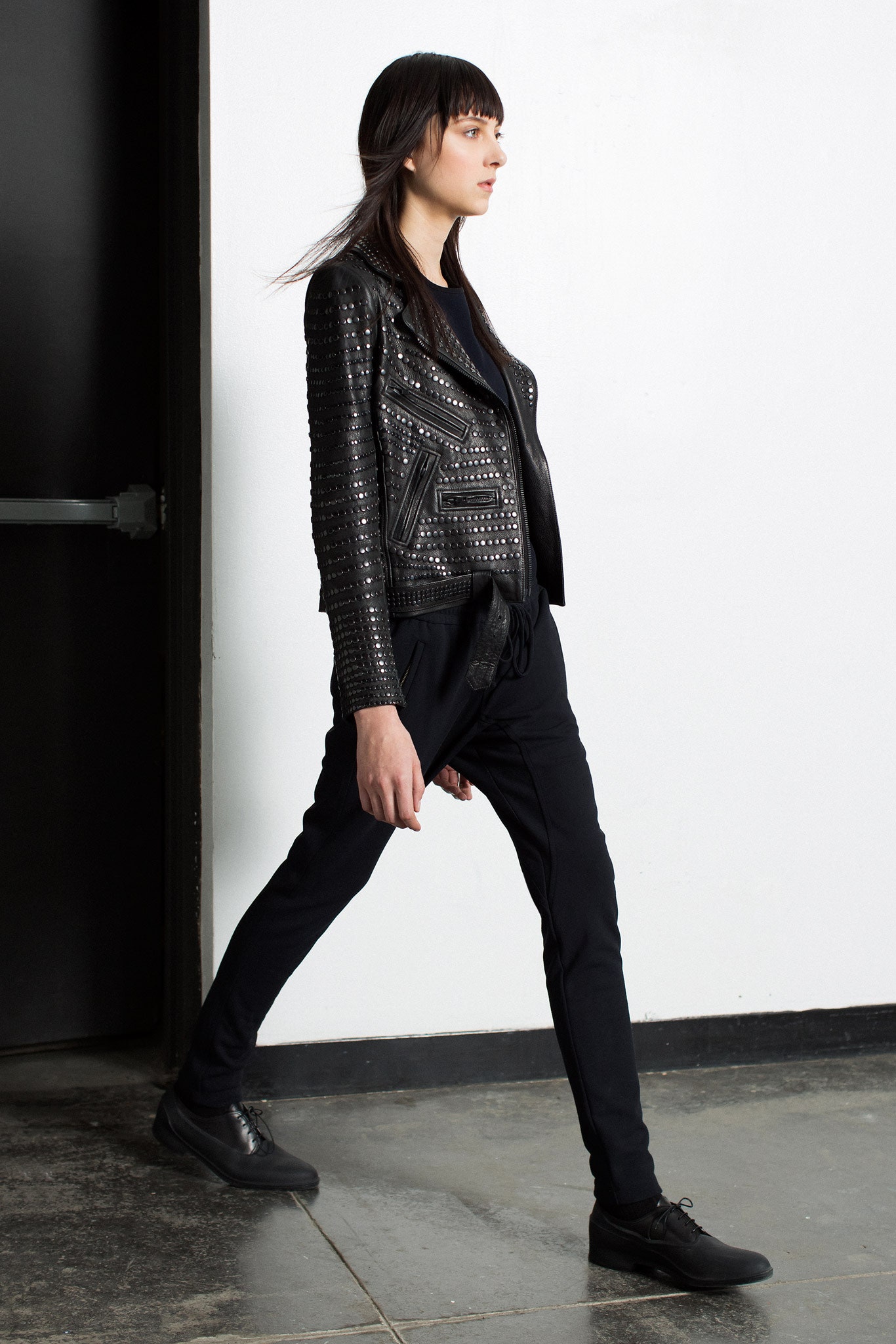 black leather fitted jacket and relaxed pants