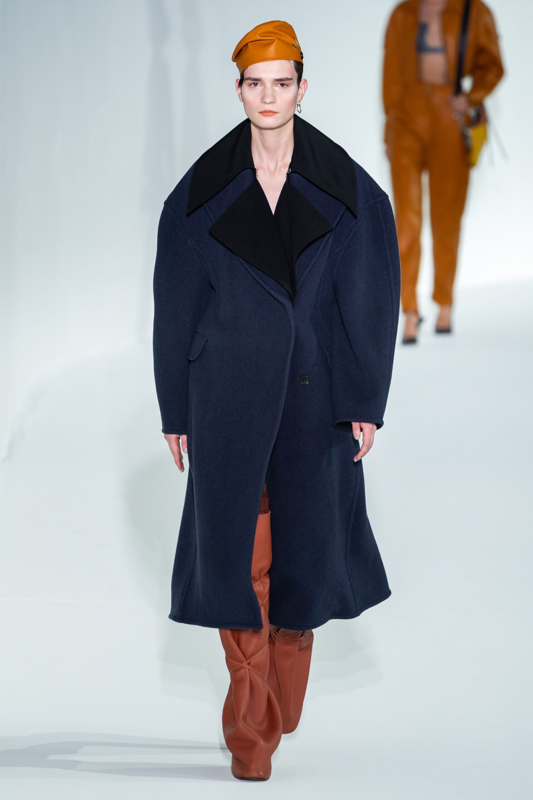 blue oversized coat with brown pants