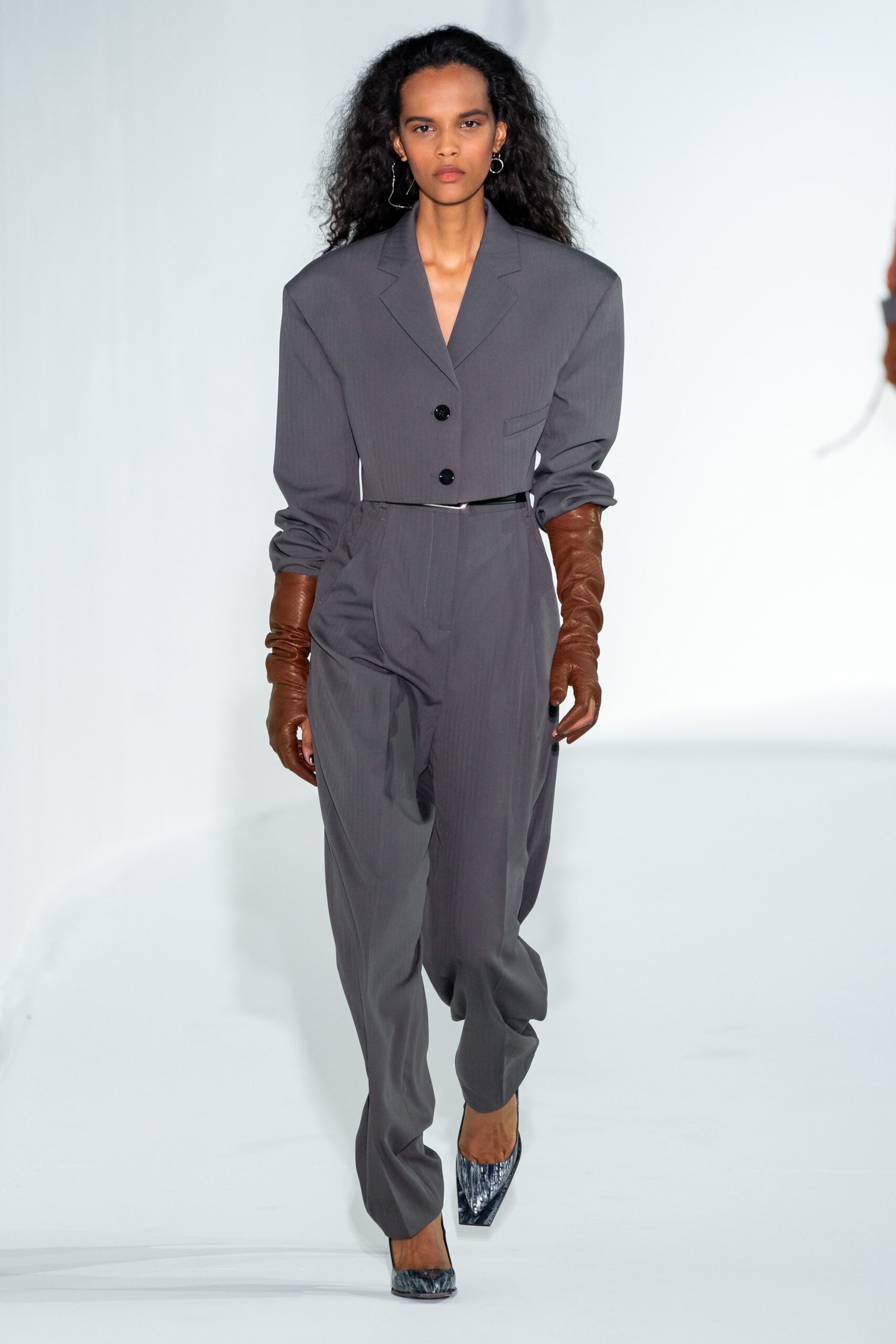 gray tailored suit with gloves