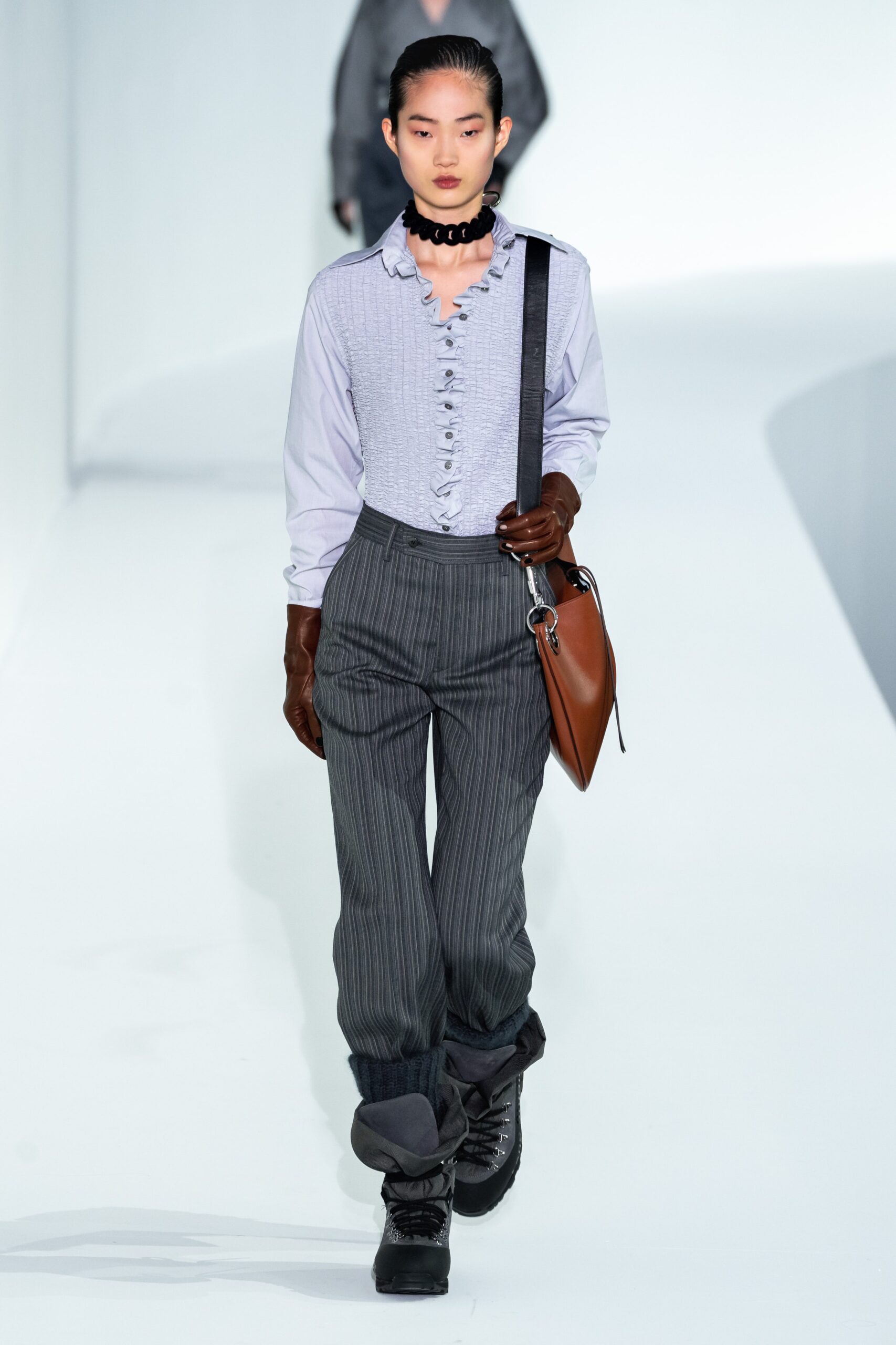 light blue ruffled shirt with gray pants