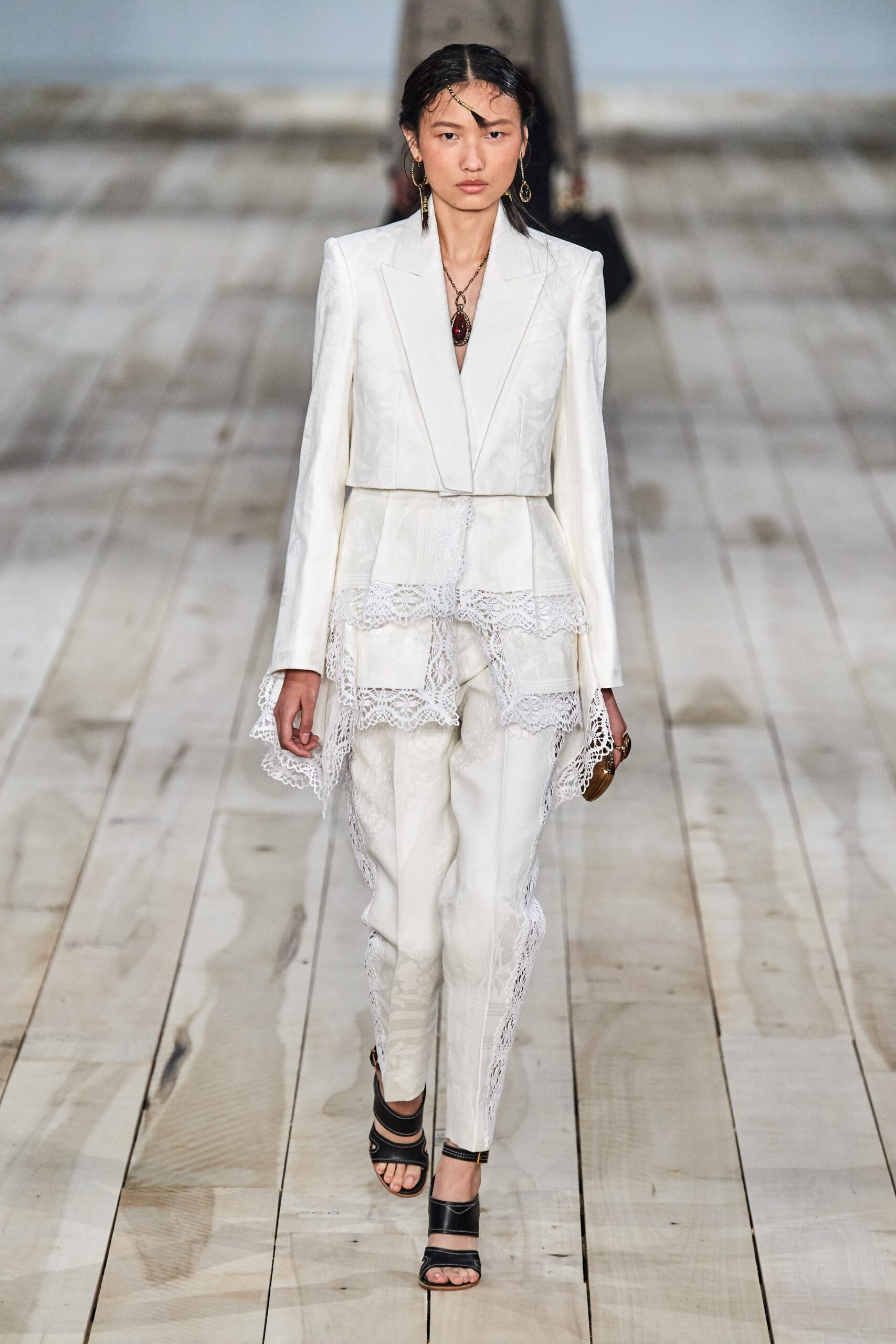 white fitted suit with strappy shoes