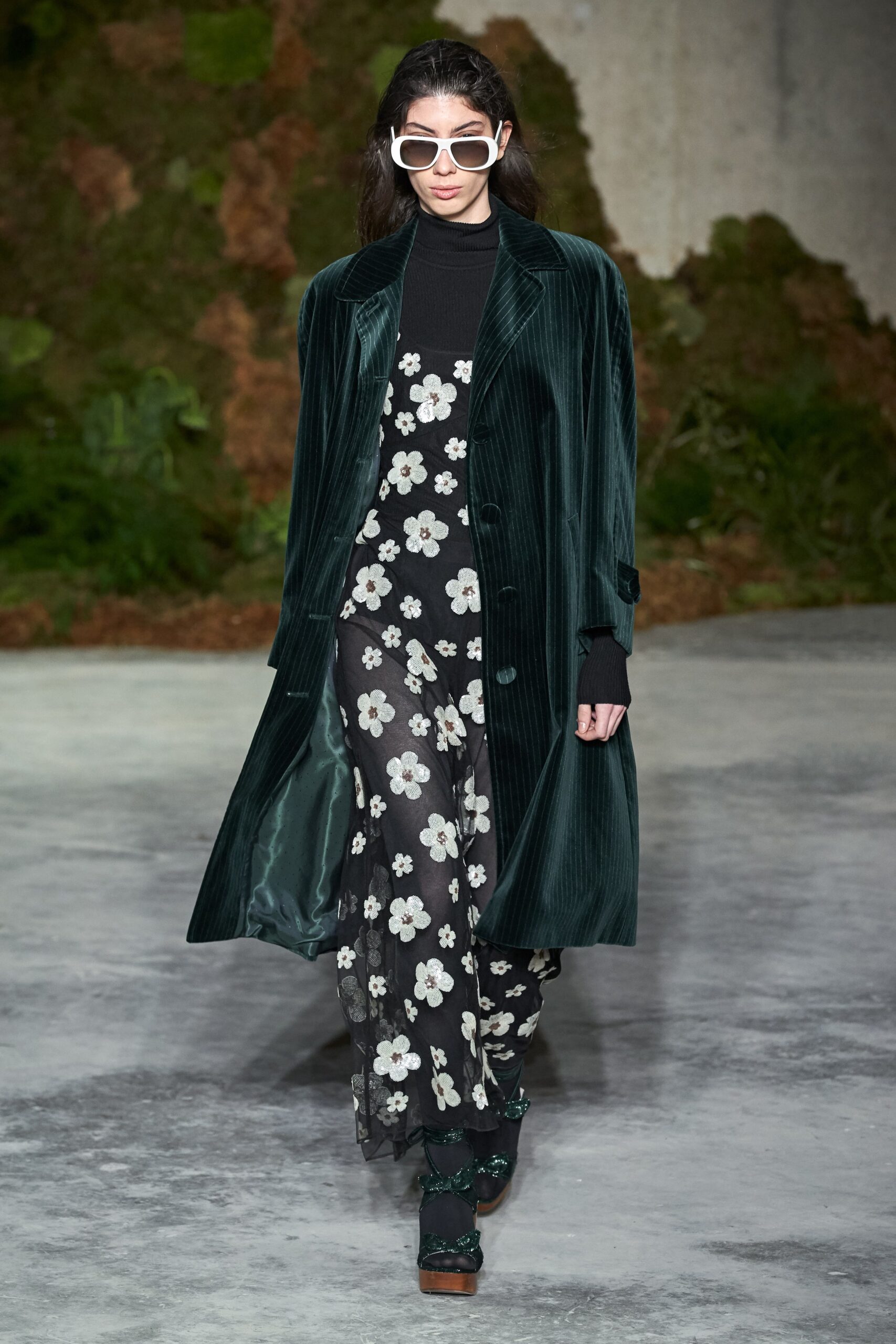green velvet coat and black jumpsuit