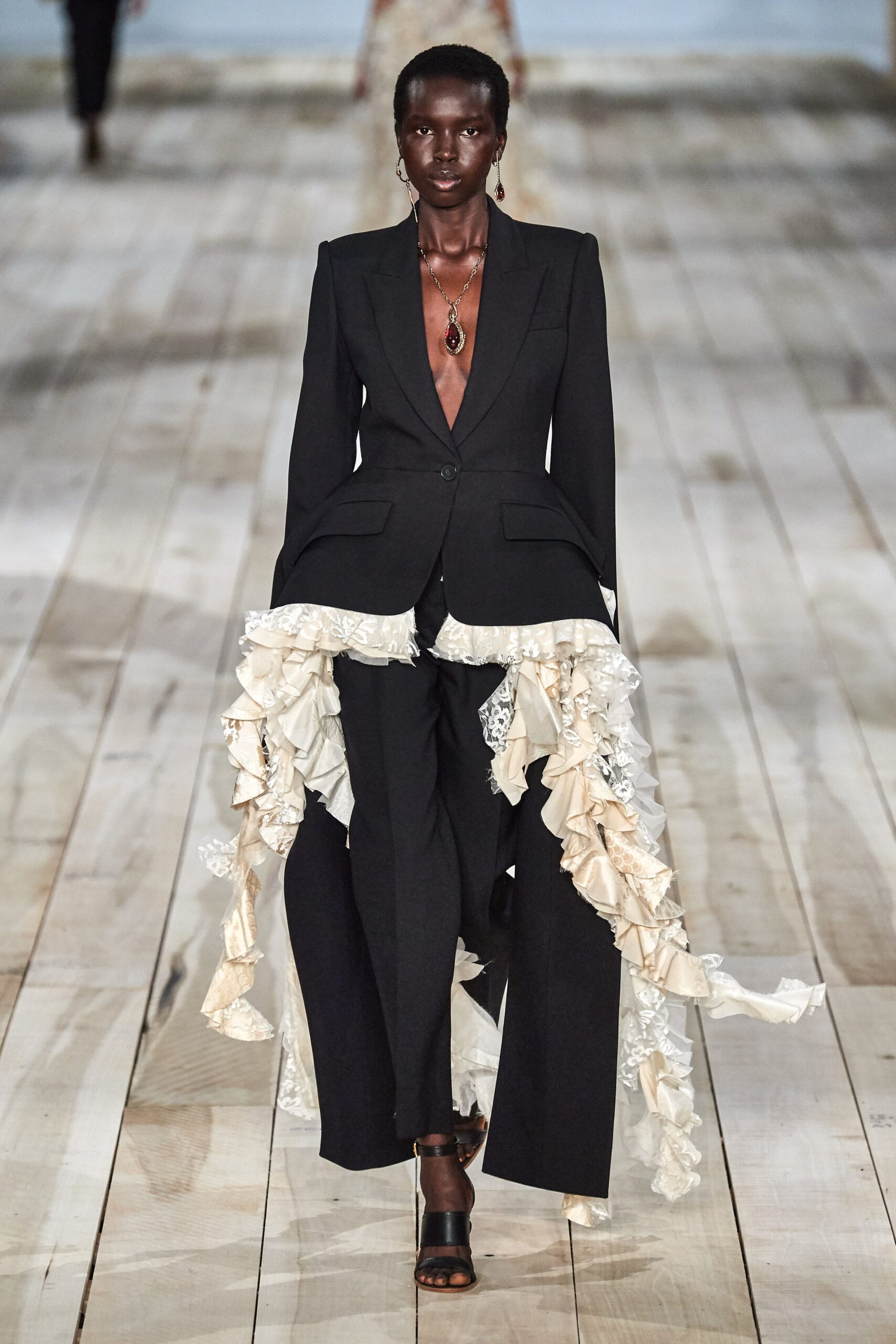black fitted suit with ruffles