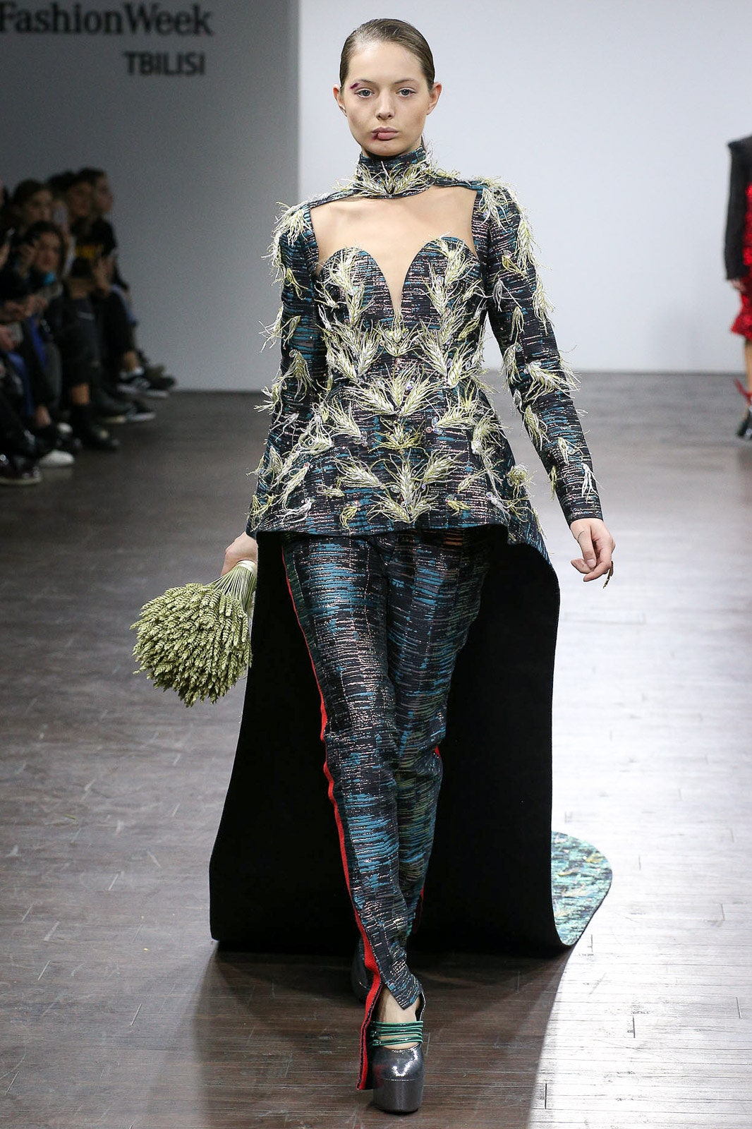 multi-colored embroidered top with black pants