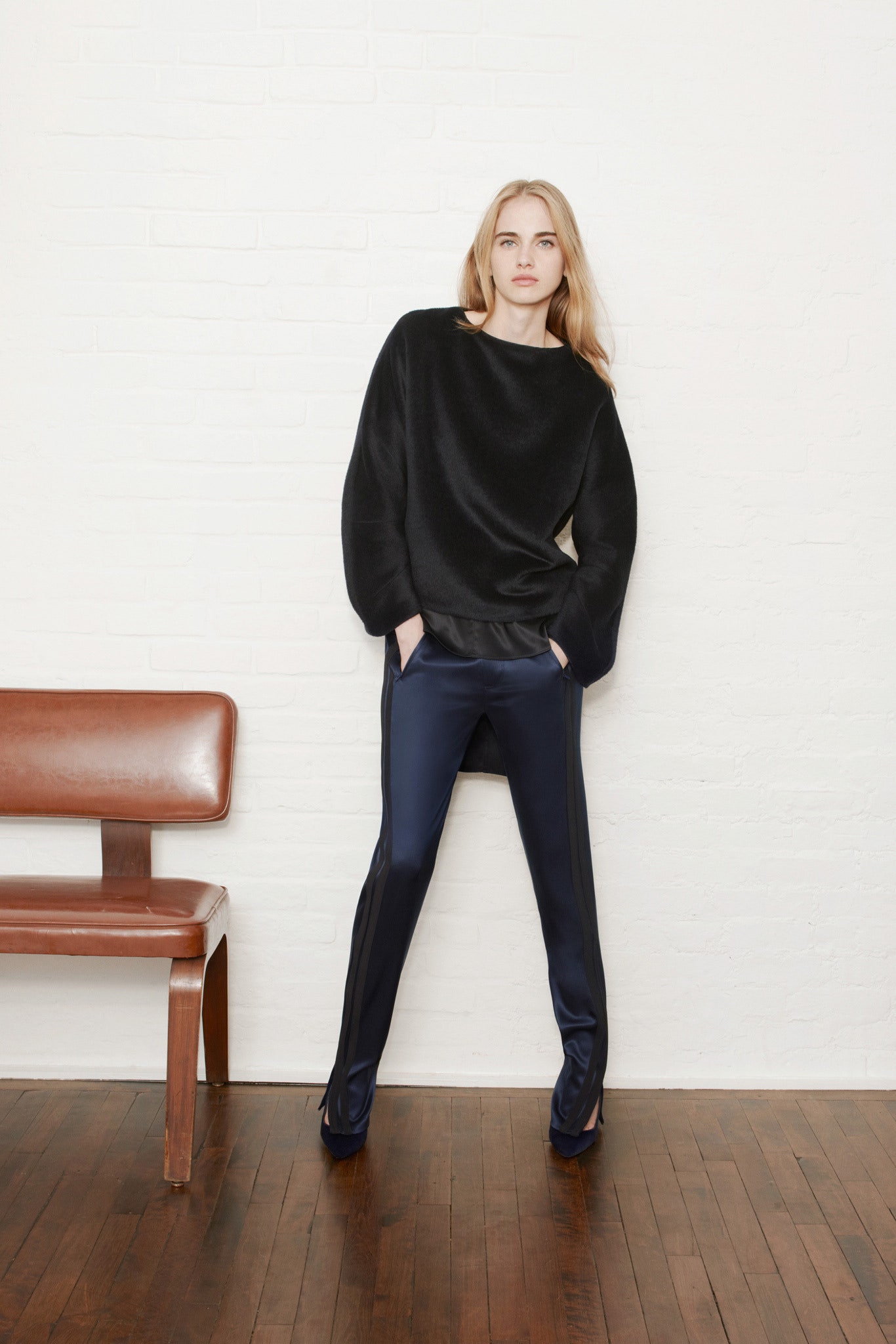 black relaxed top with blue pants