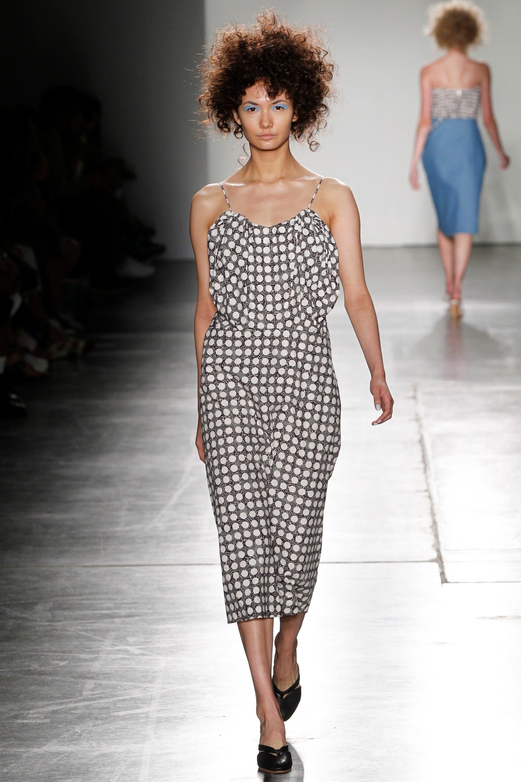 A relaxed sleeveless dress with a V-neckline featuring a black and white print.