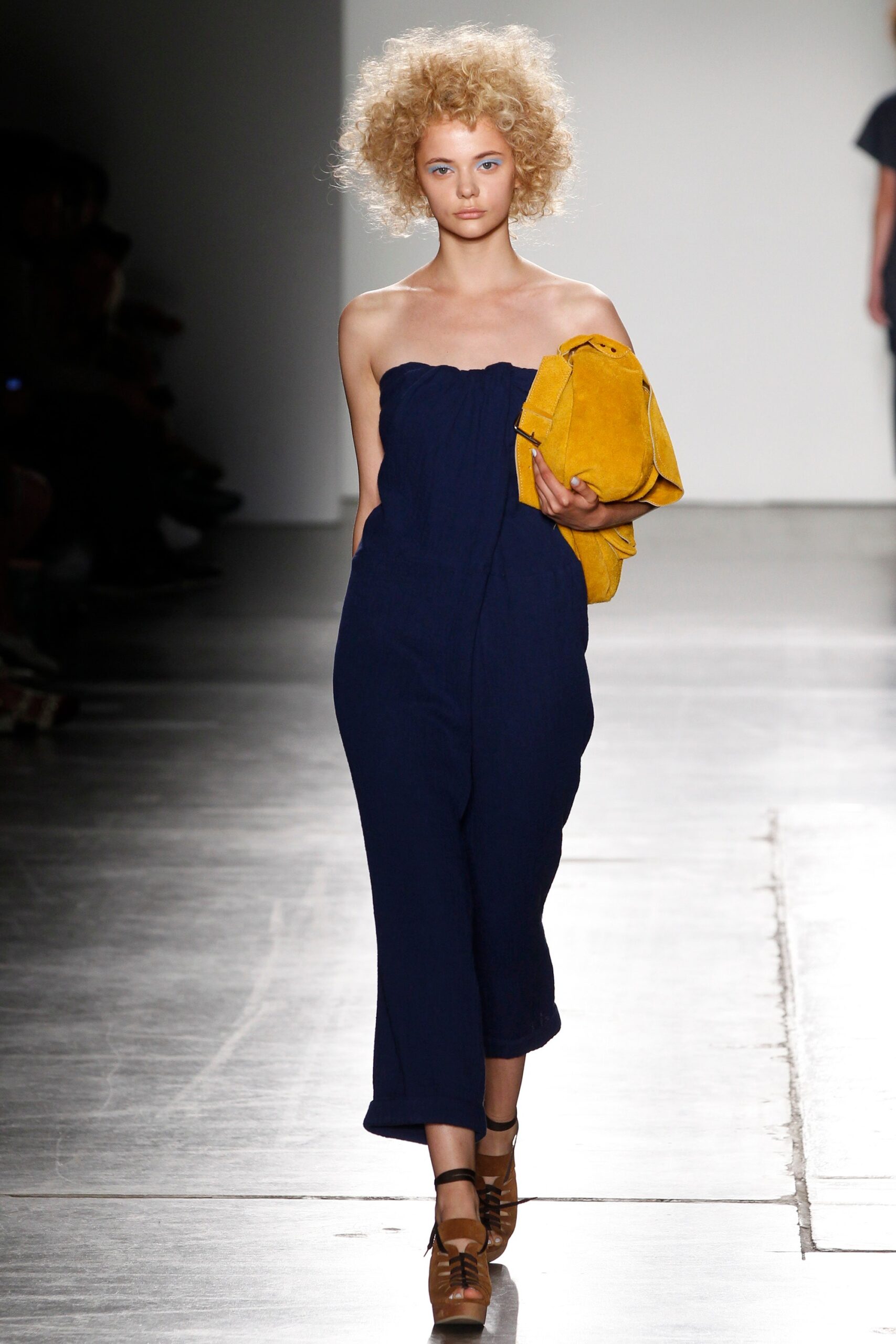 A relaxed blue cotton sleeveless jumpsuit with a straight-leg silhouette.