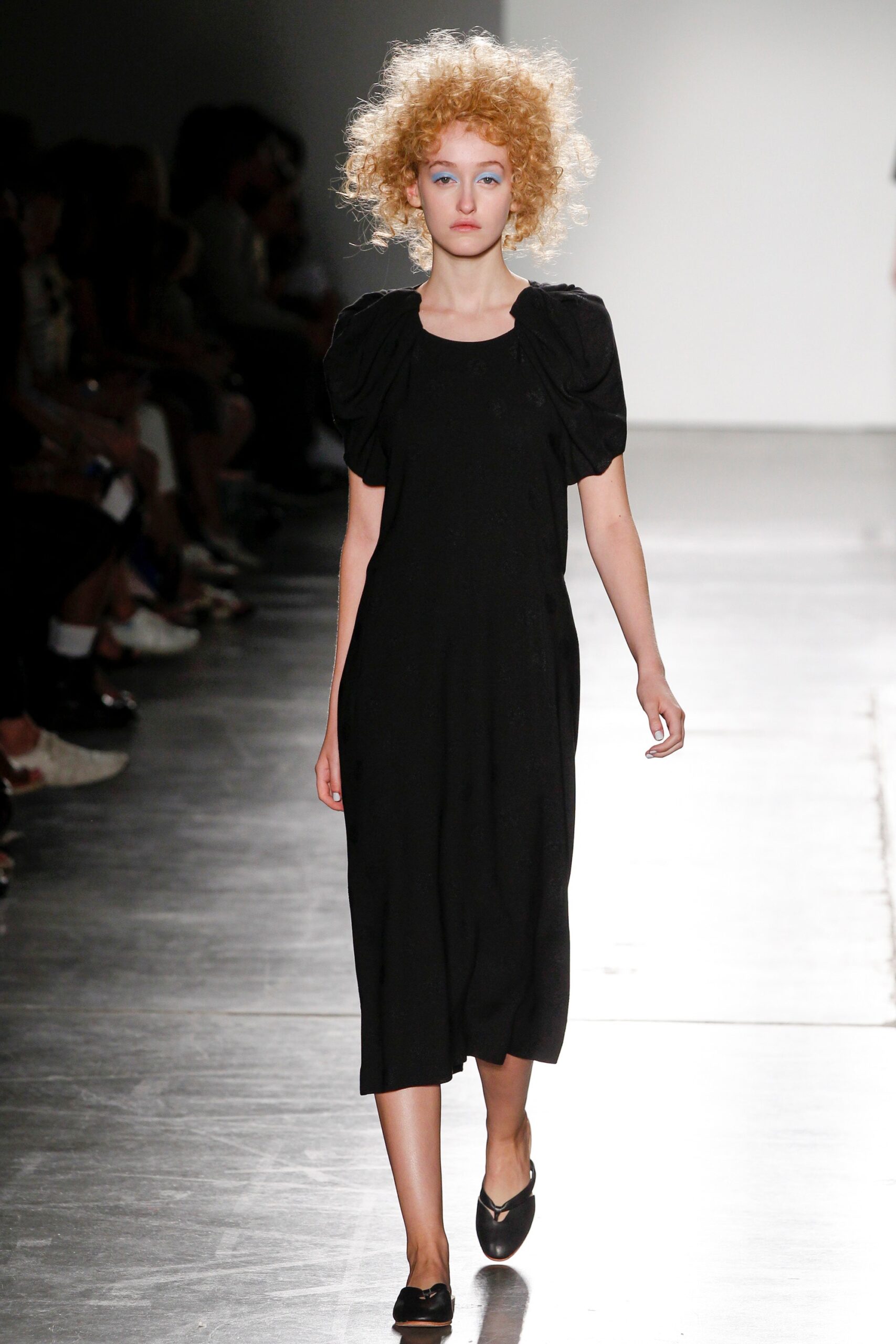 A relaxed black cotton dress with short sleeves and a crew neckline.