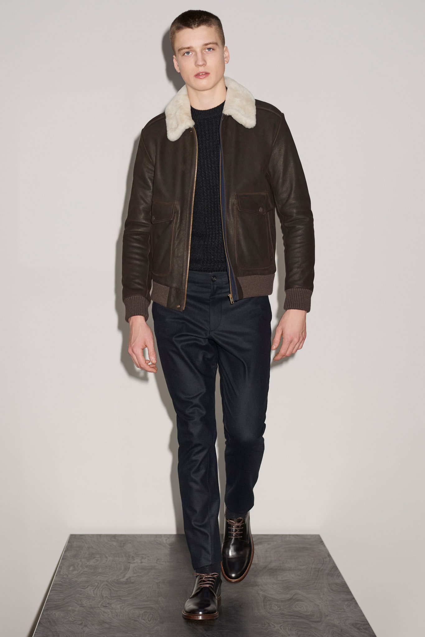 brown leather jacket with black sweater