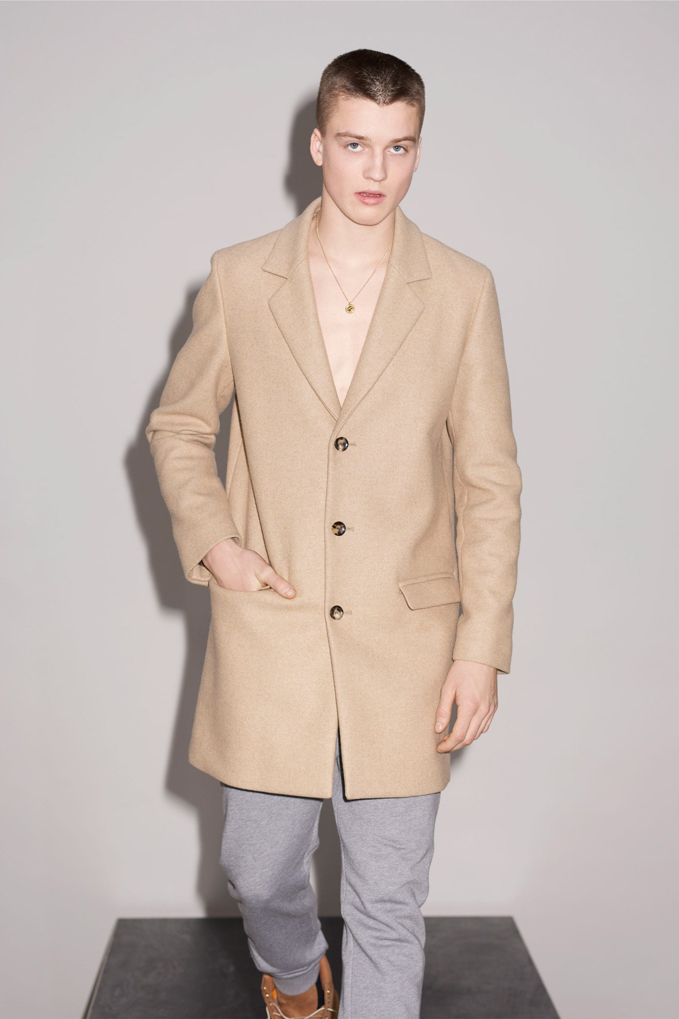 beige tailored coat with gray pants